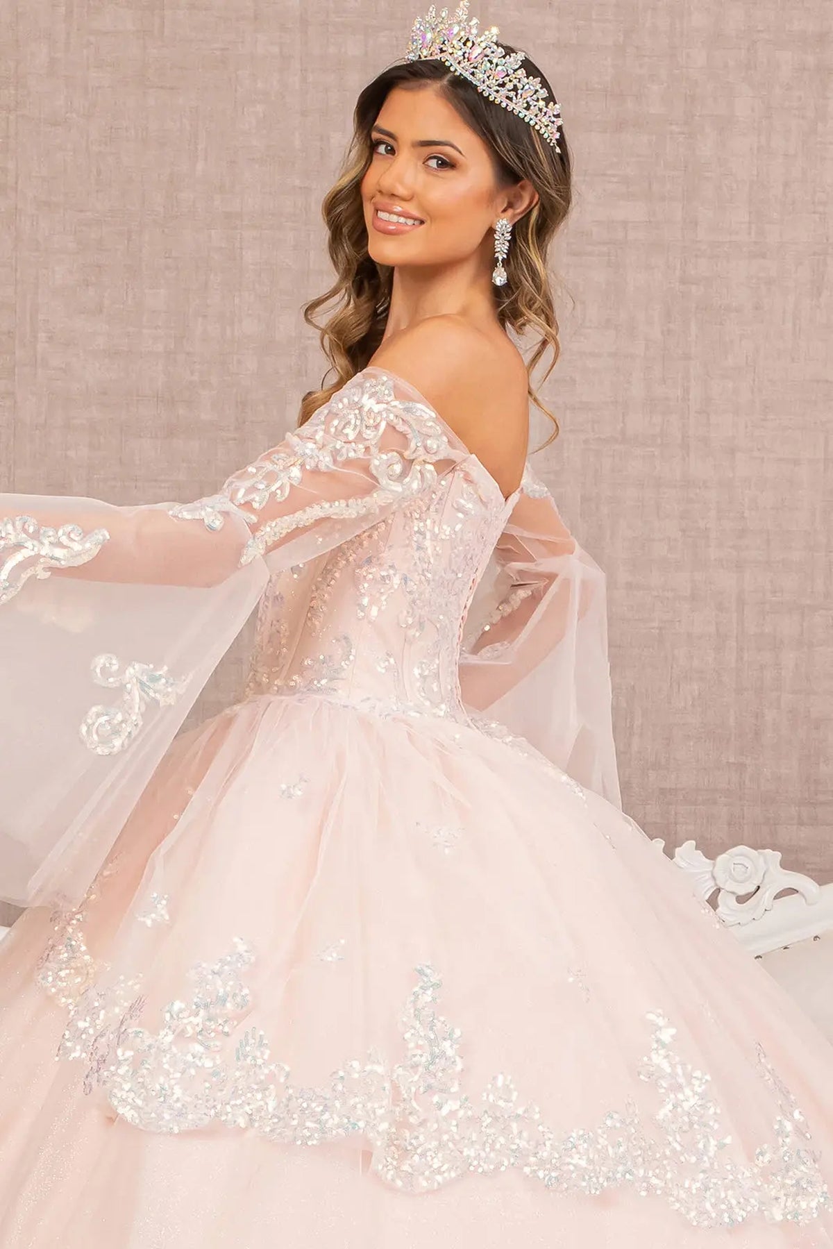 Layered skirt showcases the Blush quinceañera ball gown with layered hem.