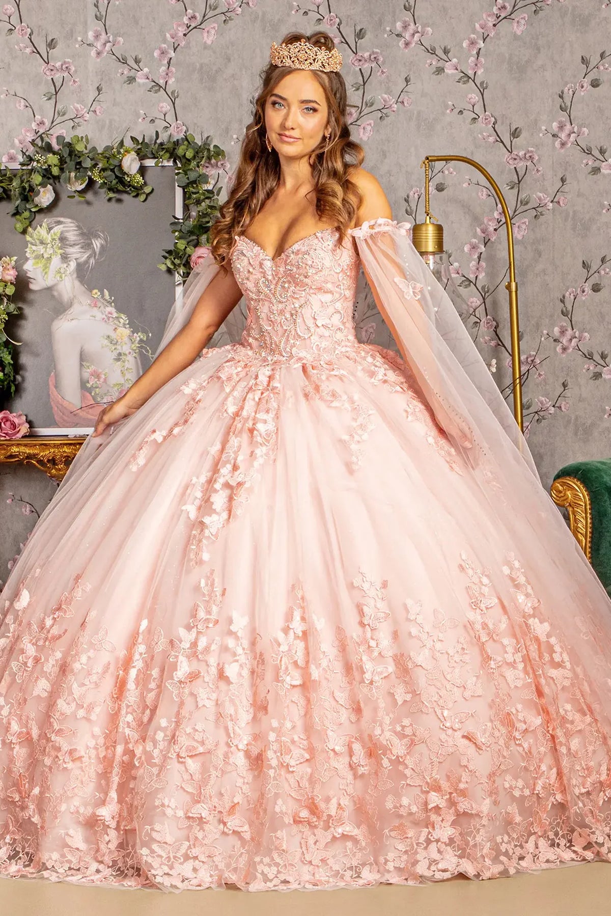 Embroidered details frame the Blush quinceañera ball gown with 3d butterfly appliqués.