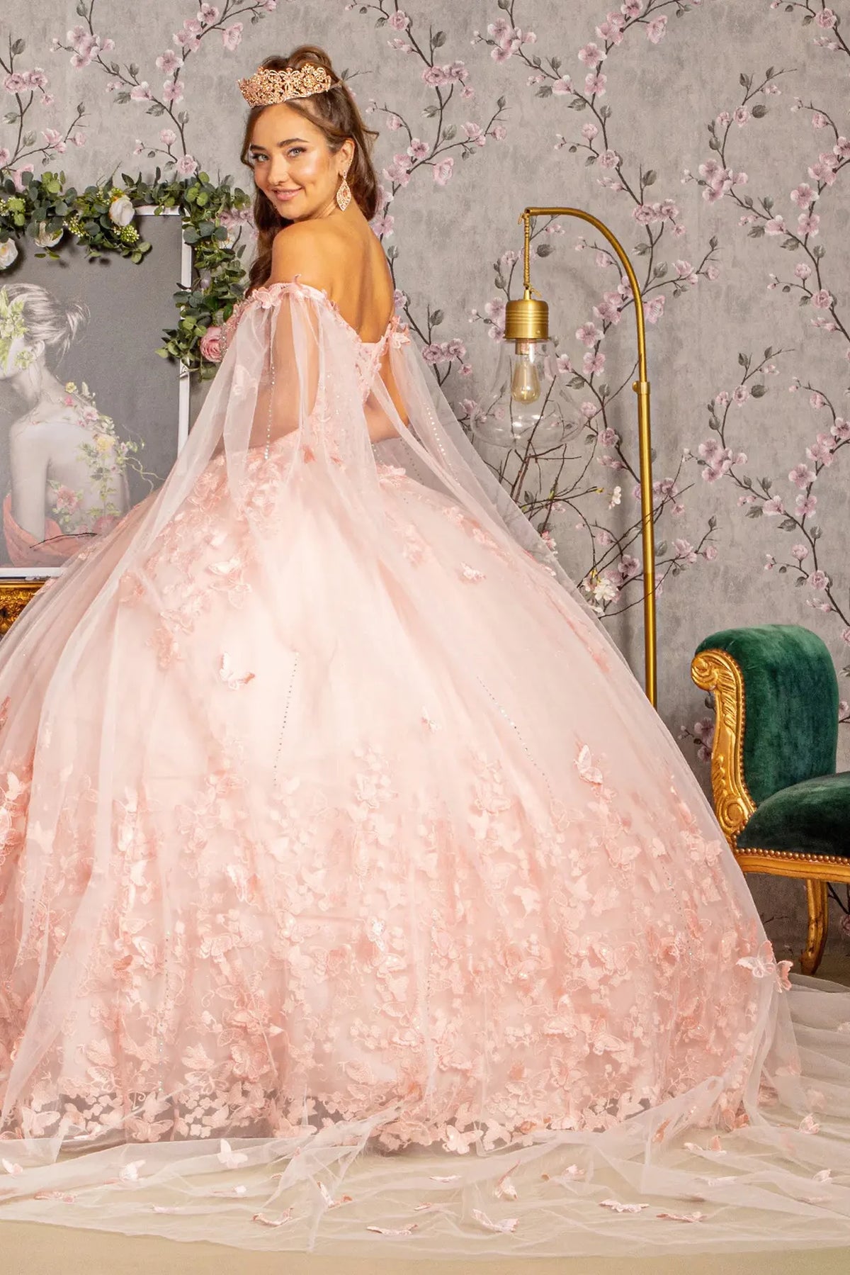 Layered skirt showcases the Blush quinceañera ball gown with 3d butterfly appliqués.