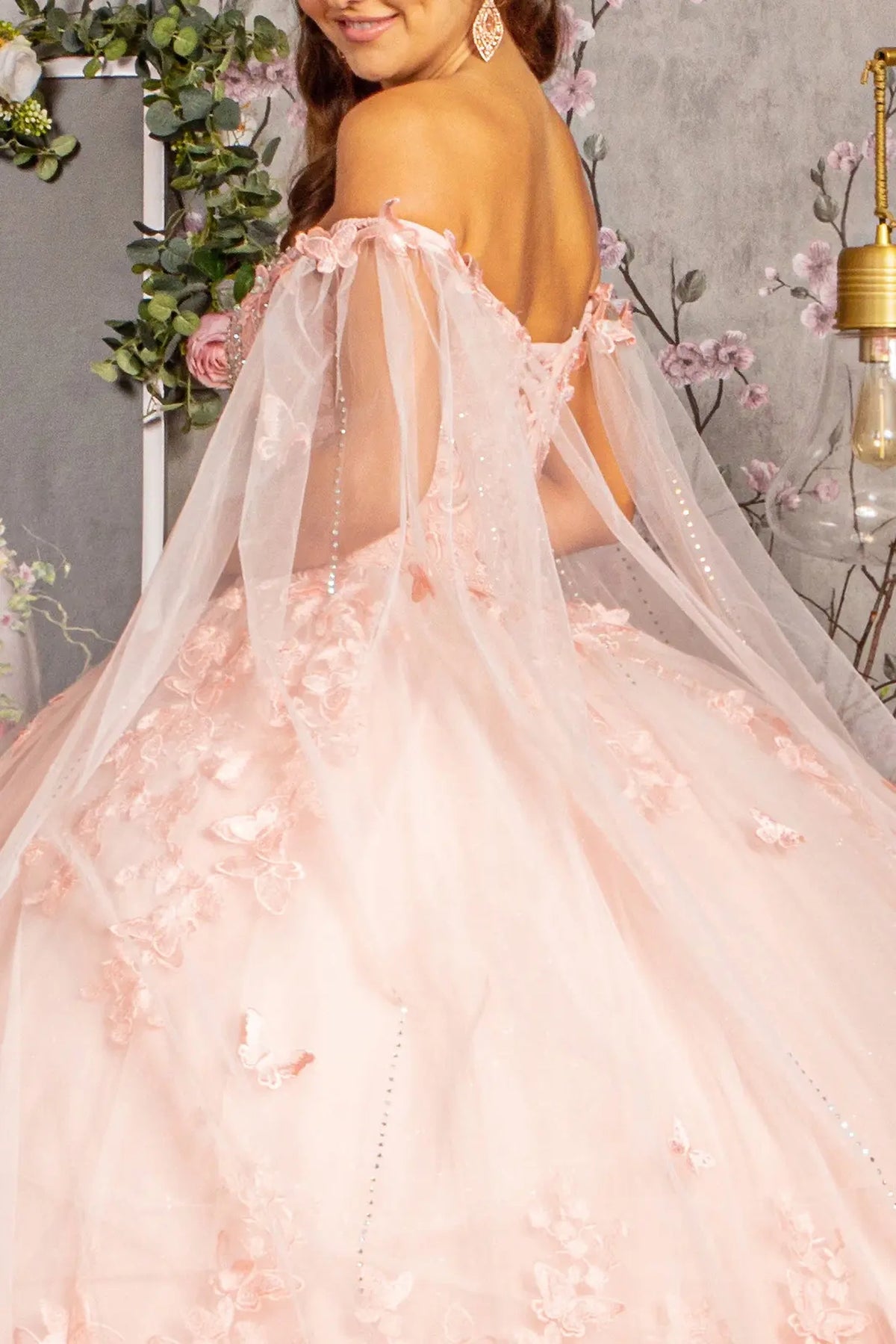 Detachable accents complete the Blush quinceañera ball gown with 3d butterfly appliqués.