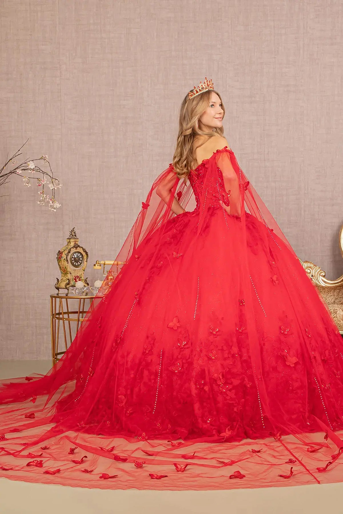 Bodice close-up highlights the Red quinceañera ball gown with long mesh drape.