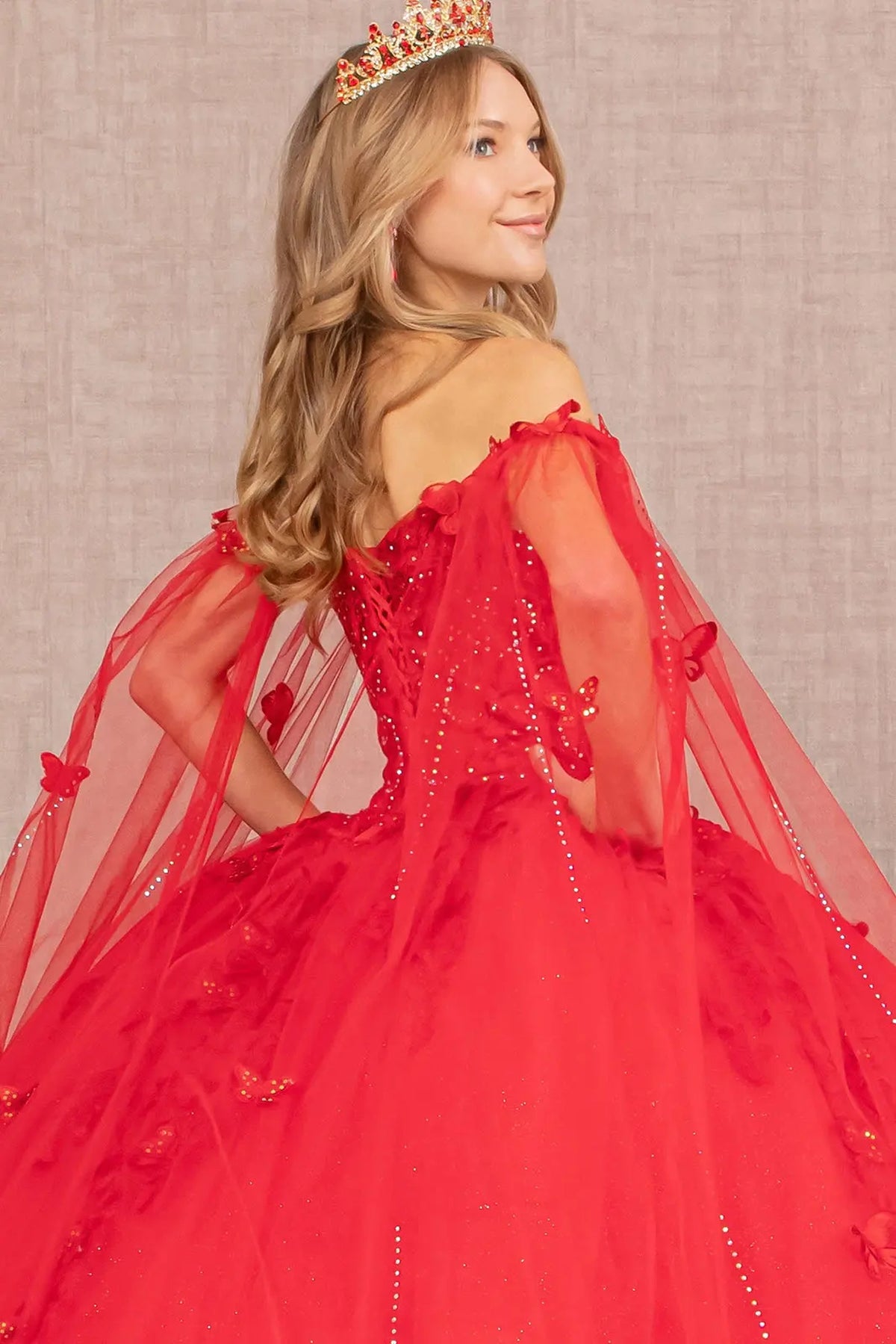 Layered skirt showcases the Red quinceañera ball gown with 3d butterfly appliqués.