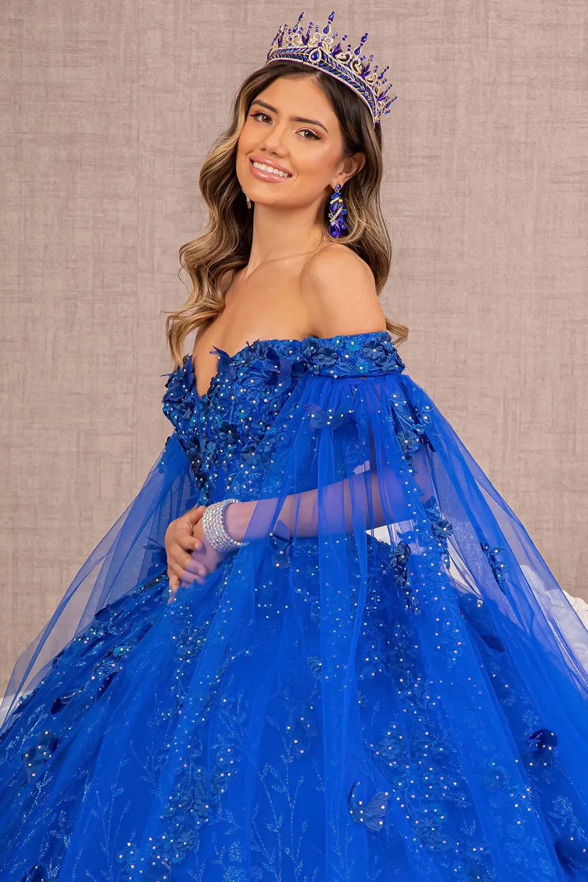 Full-length view presents the Royal Blue quinceañera ball gown with long mesh drapes.