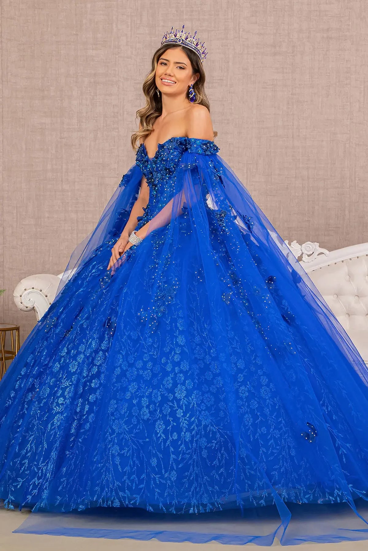 Embroidered details frame the Royal Blue quinceañera ball gown with long mesh drapes.