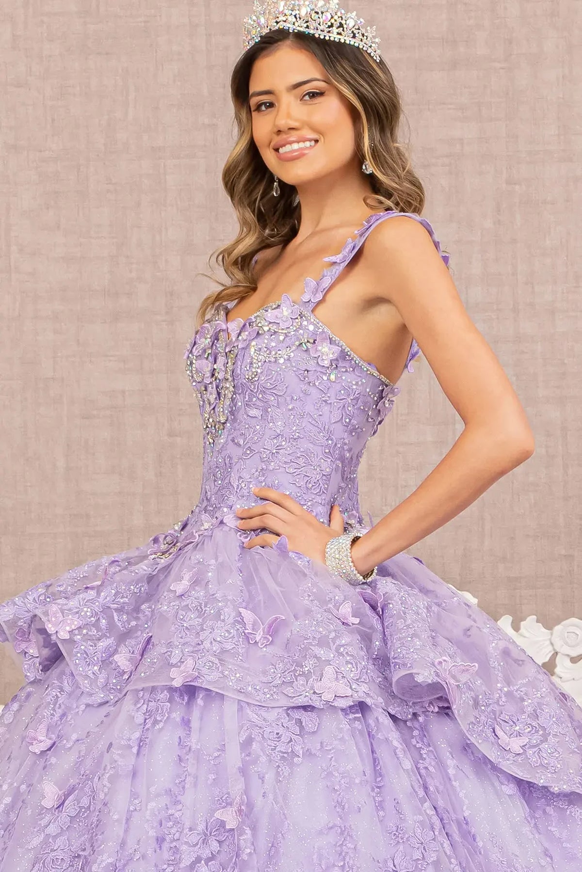Embroidered details frame the Lilac quinceañera ball gown with 3d butterfly appliqués.