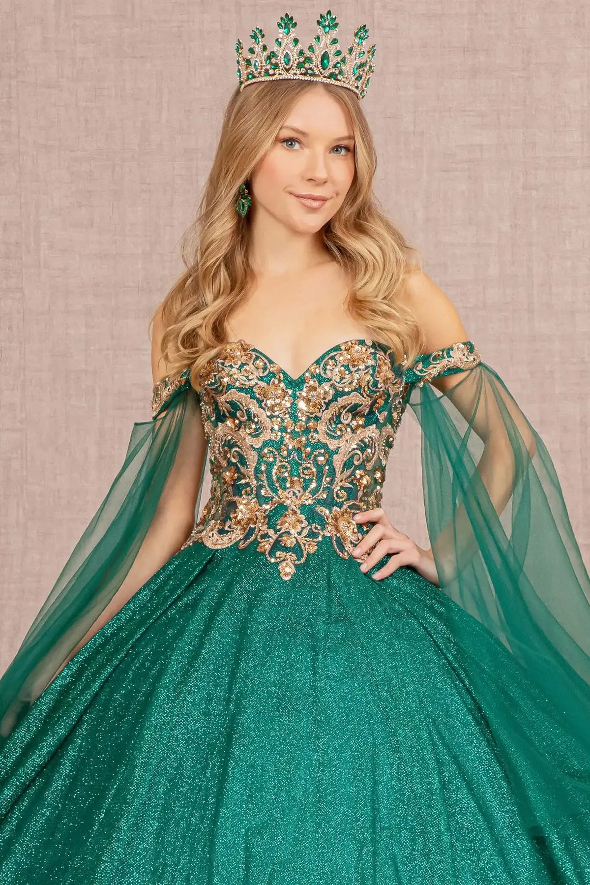 Full-length view presents the Emerald Green quinceañera ball gown with detachable mesh drapes.