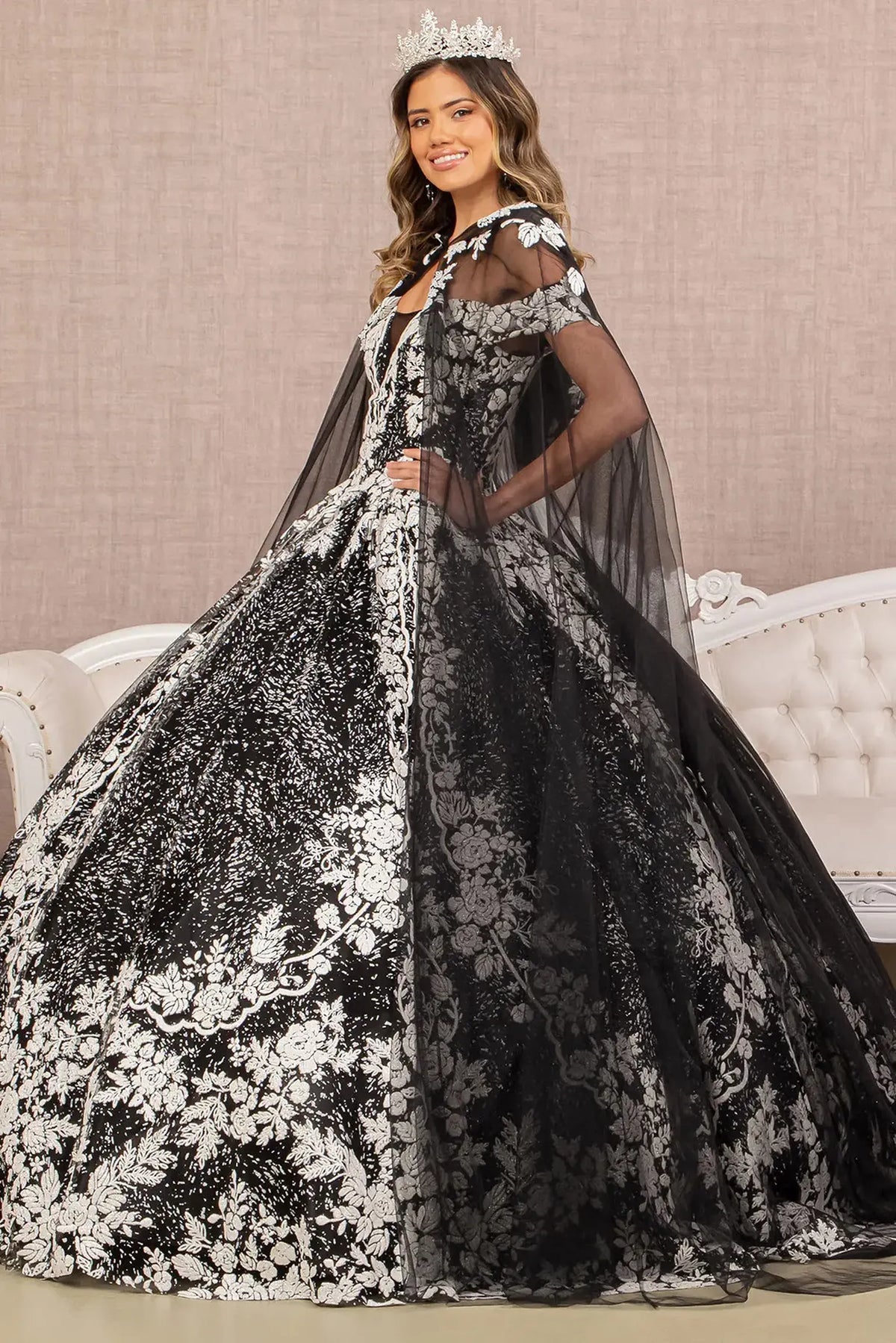 Embroidered details frame the Black/White quinceañera ball gown with hooded mesh cape.
