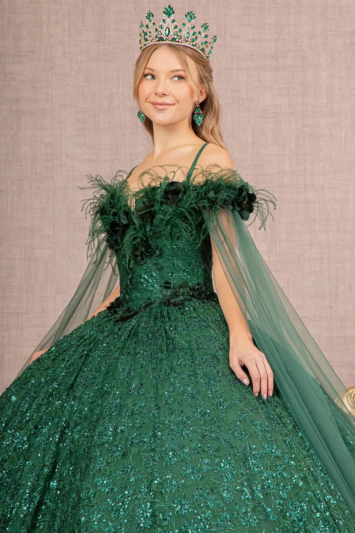 Full-length view presents the Green quinceañera ball gown with feather trim.