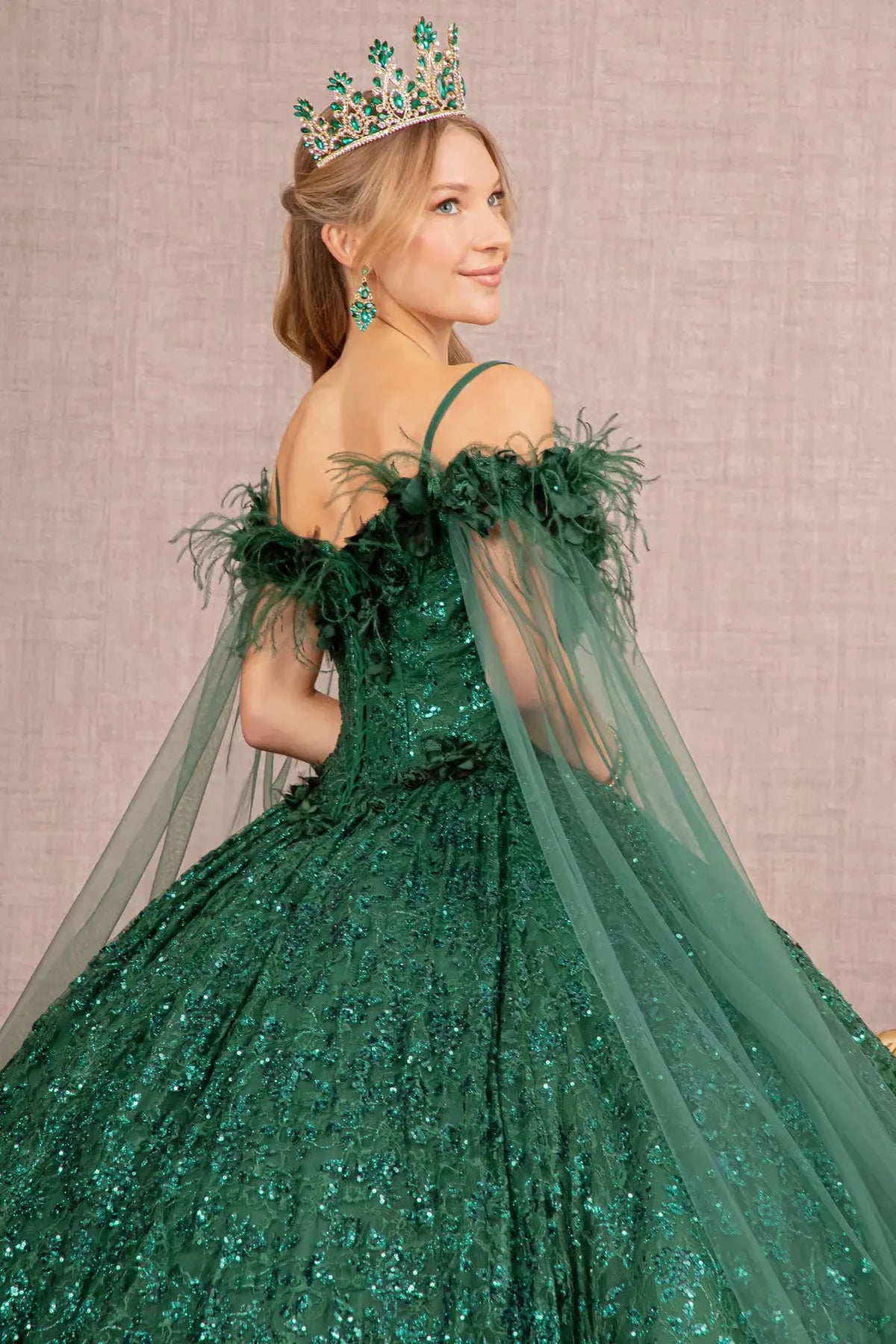 Embroidered details frame the Green quinceañera ball gown with feather trim.