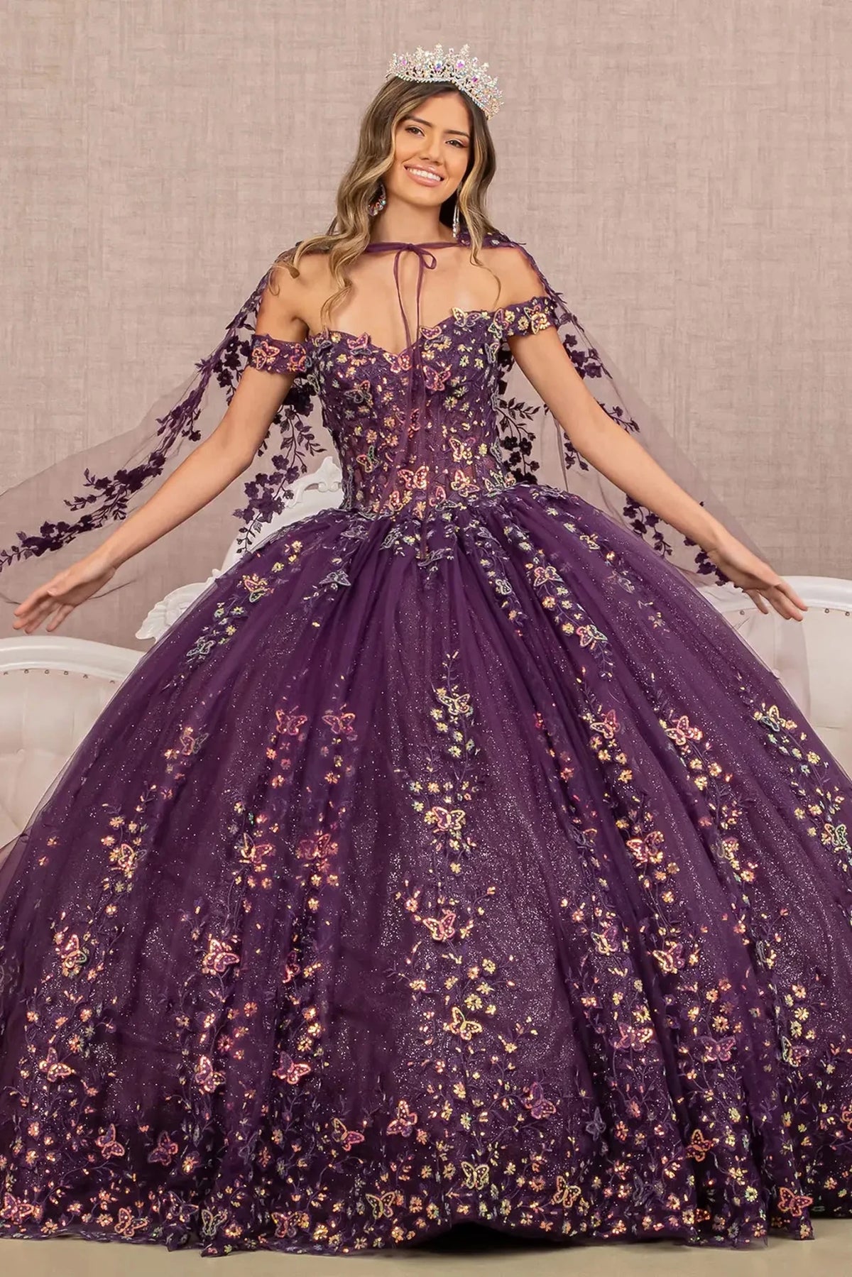 Lace-up back reveals the Purple quinceañera ball gown with lace-up back and long mesh cape.