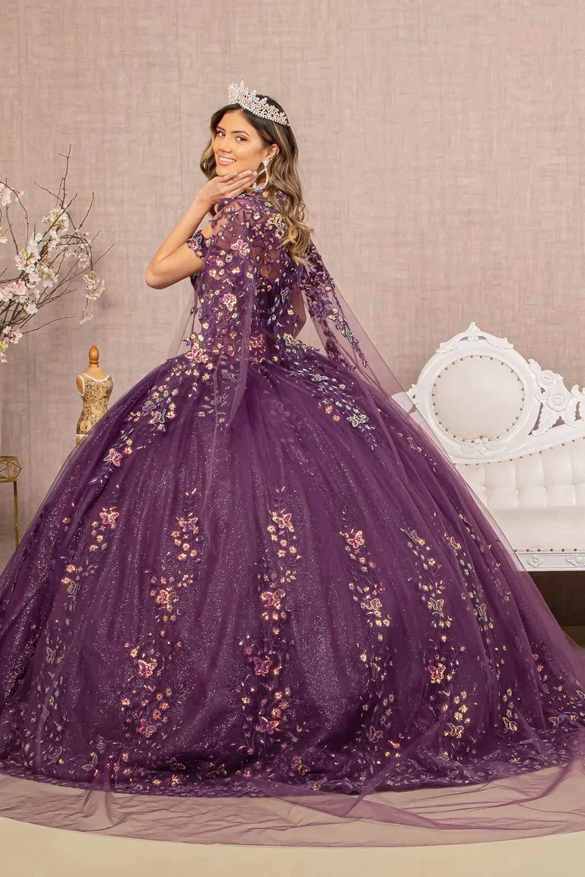 Bodice close-up highlights the Purple quinceañera ball gown with long mesh cape.