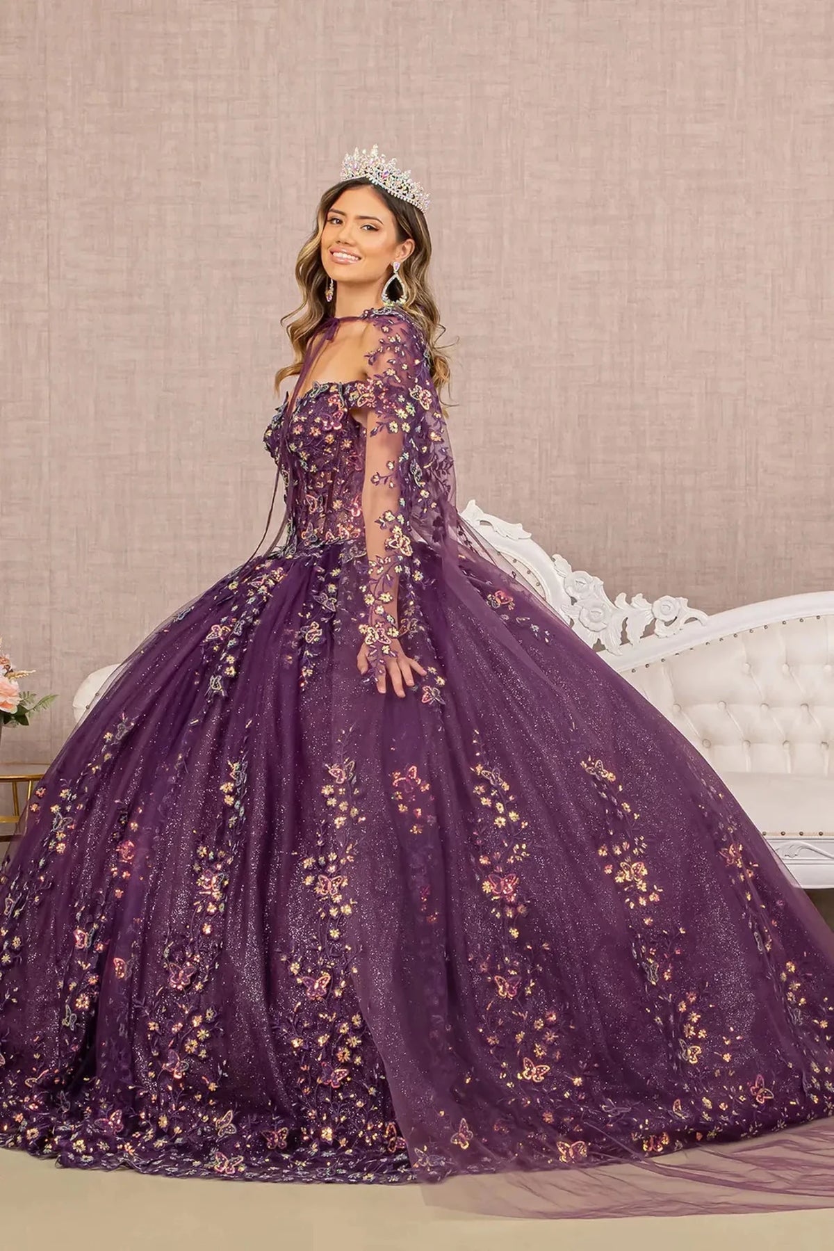 Embroidered details frame the Purple quinceañera ball gown with 3d butterfly appliqués.