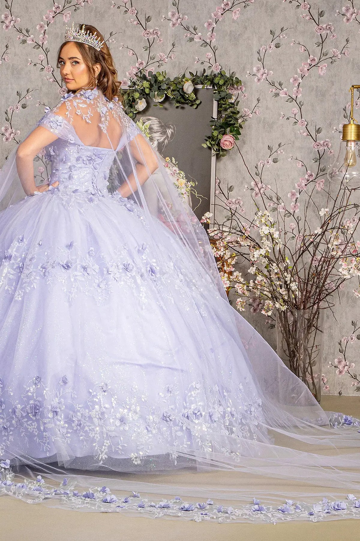 Bodice close-up highlights the Lilac quinceañera ball gown with 3d floral appliqués.