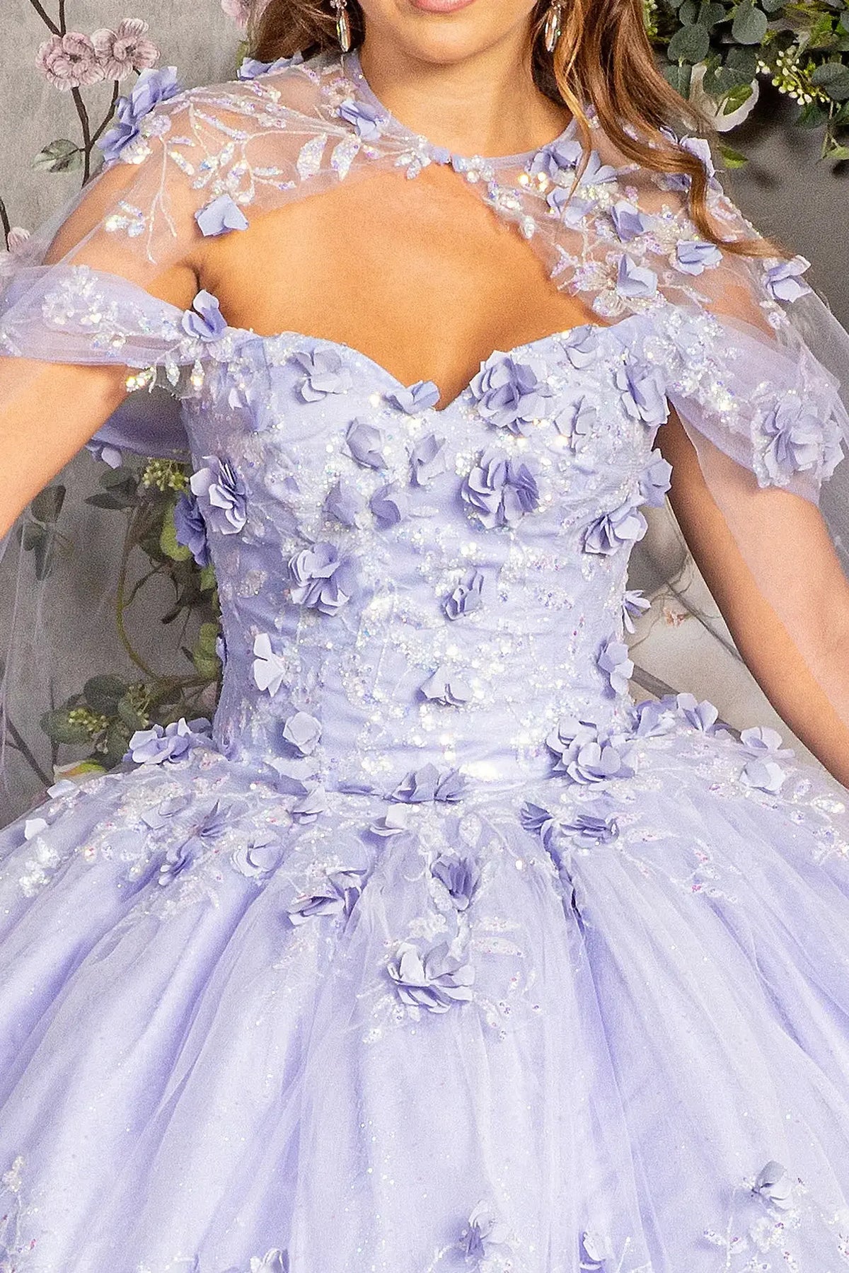 Embroidered details frame the Lilac quinceañera ball gown with long mesh cape.