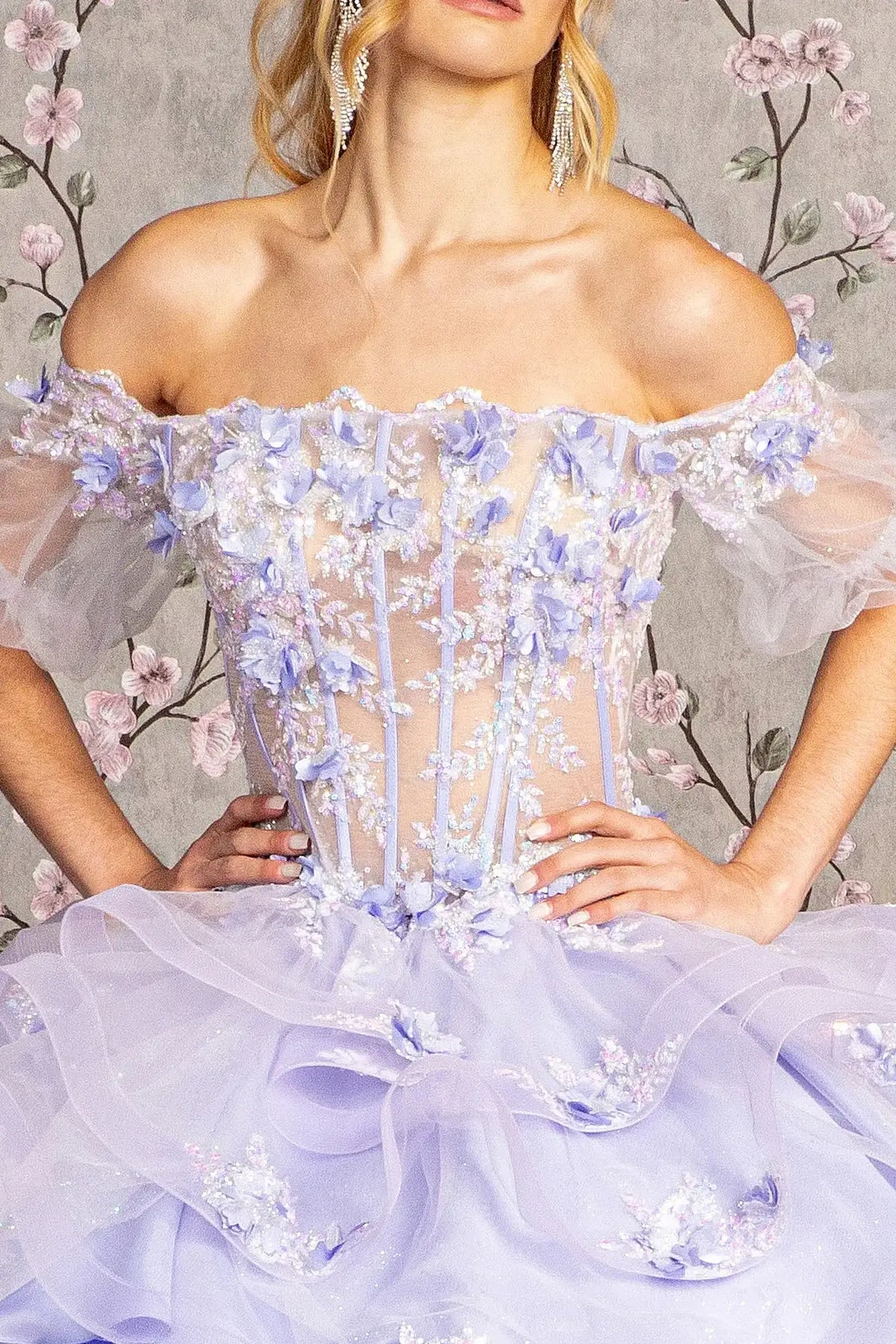 Layered skirt showcases the Lilac quinceañera ball gown with ruffled skirt.