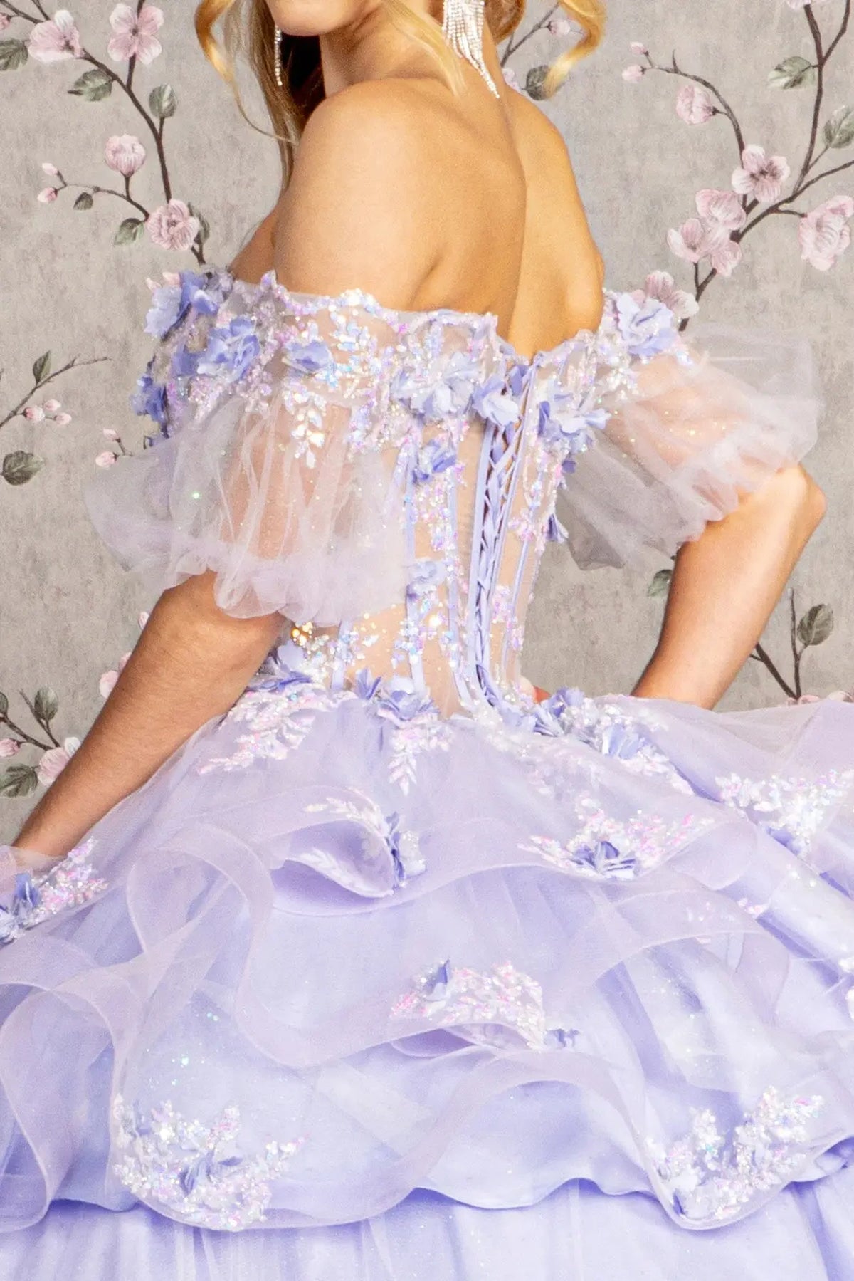 Detachable accents complete the Lilac quinceañera ball gown with ruffled skirt.