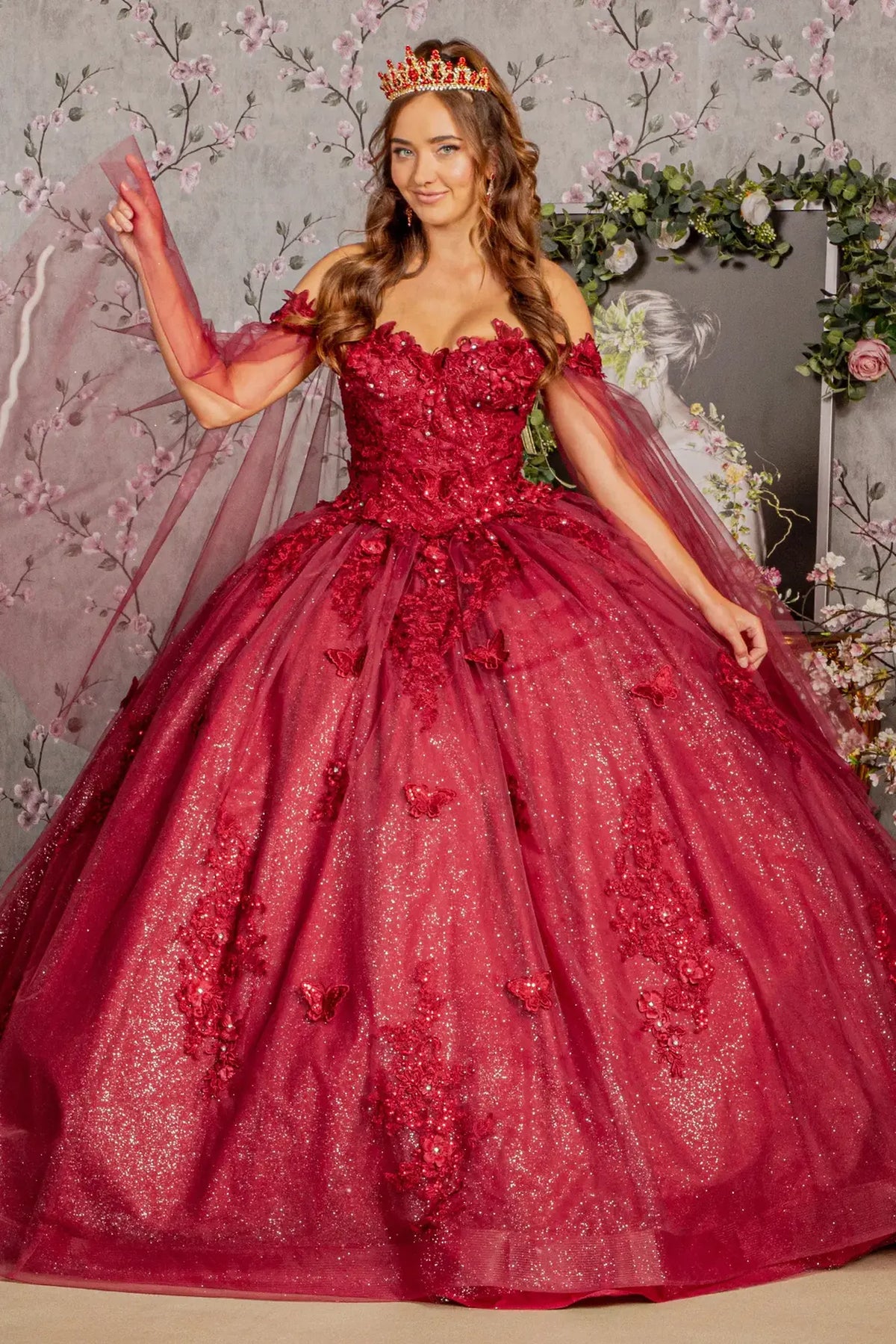 Full-length view presents the Burgundy quinceañera ball gown with detachable mesh drapes.