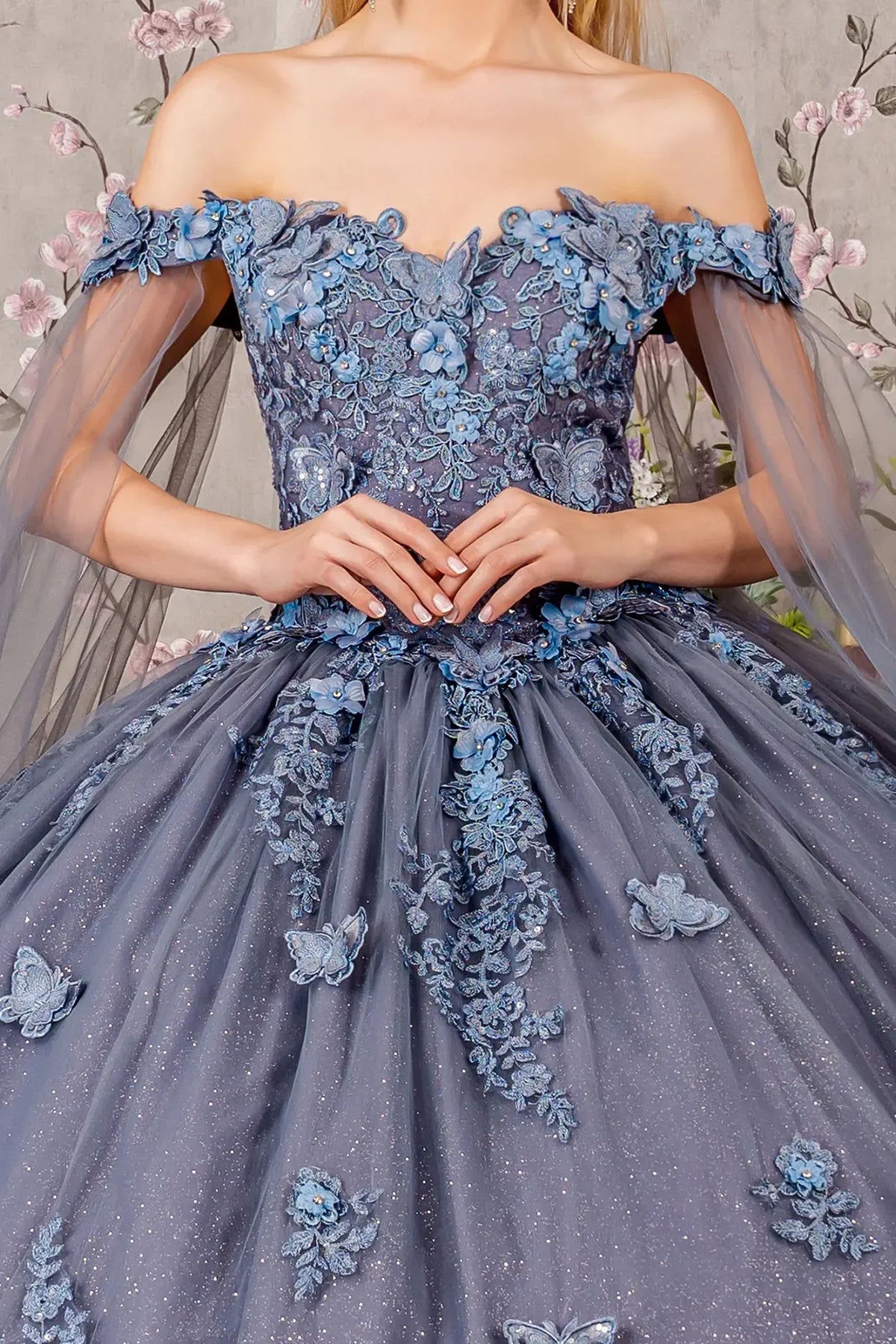 Full-length view presents the Smoky Blue quinceañera ball gown with detachable mesh drapes.