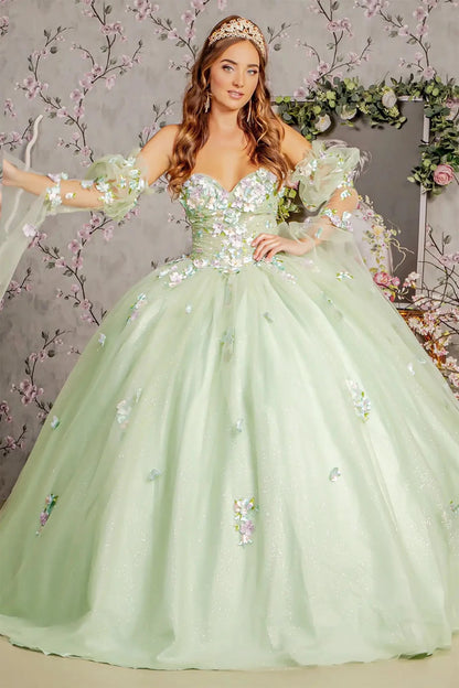 Woman in a light green sequined gown with floral embellishments against a decorative background.
