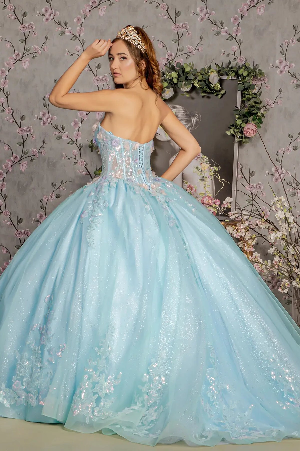 Layered skirt showcases the Tiffany Blue quinceañera ball gown with 3d floral embroidery.