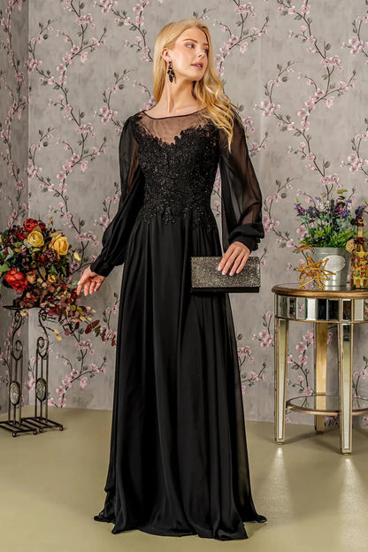Detailed view highlights black chiffon a-line mother of the bride dress with boat-neck.