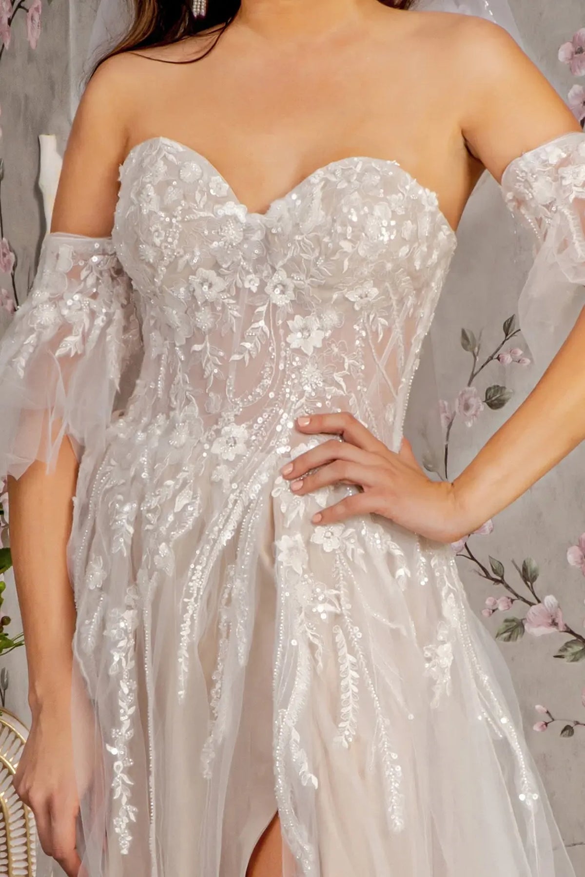 Floral beading decorates the sheer sweetheart bodice of the Ivory/Champagne wedding gown.