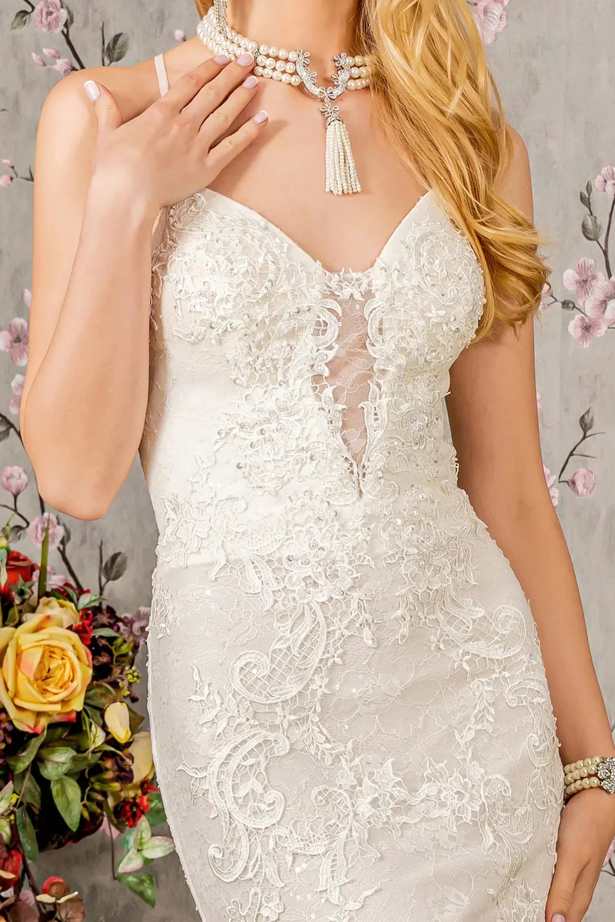 Ivory wedding gown with sparkling floral lace framing an illusion sweetheart bodice.