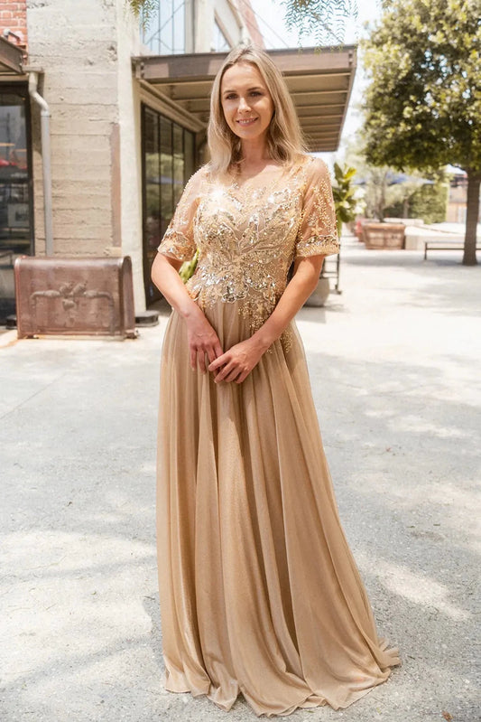 Back detail shows gold mother of the bride dress featuring concealed zipper back bodice finished with beads, embroidery, metallic.