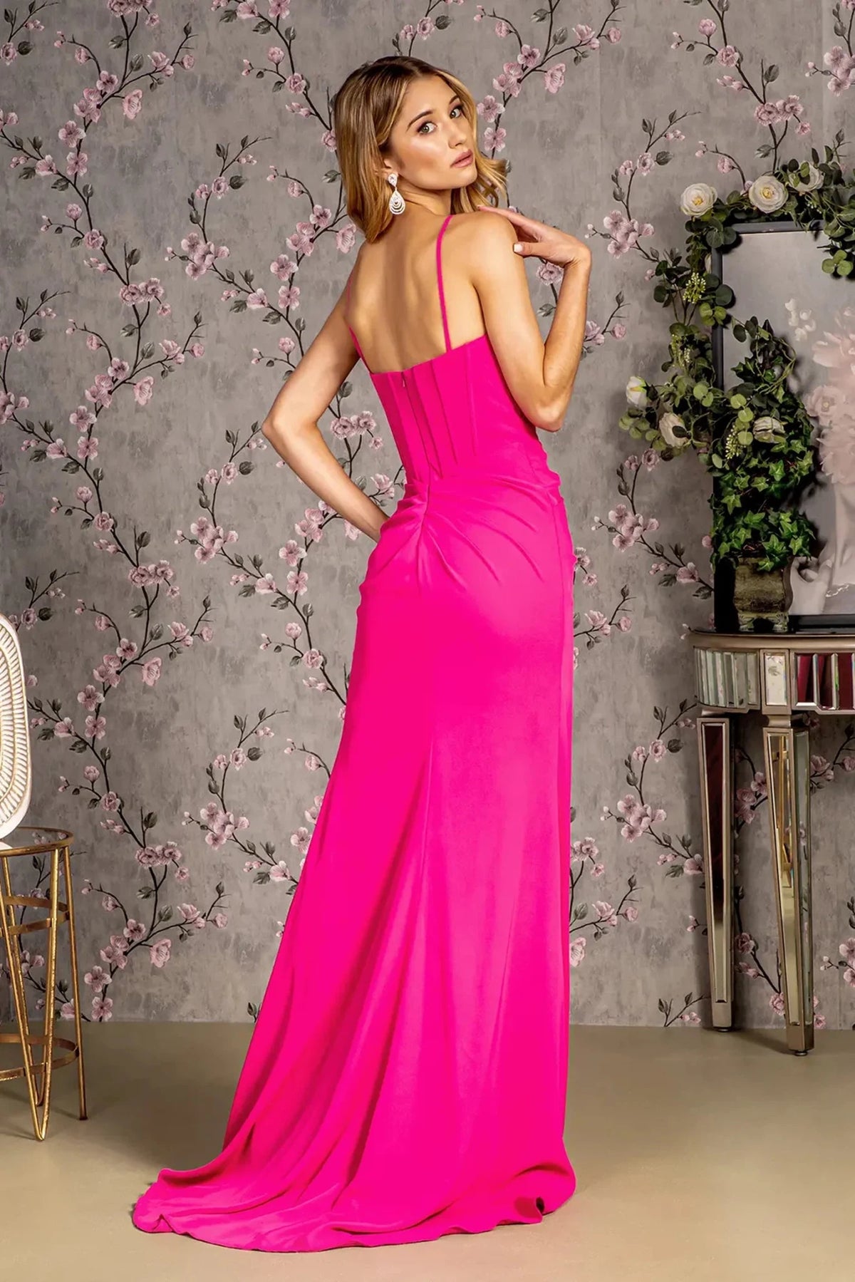 Rear view highlights the open back of the Fuchsia prom evening dress.