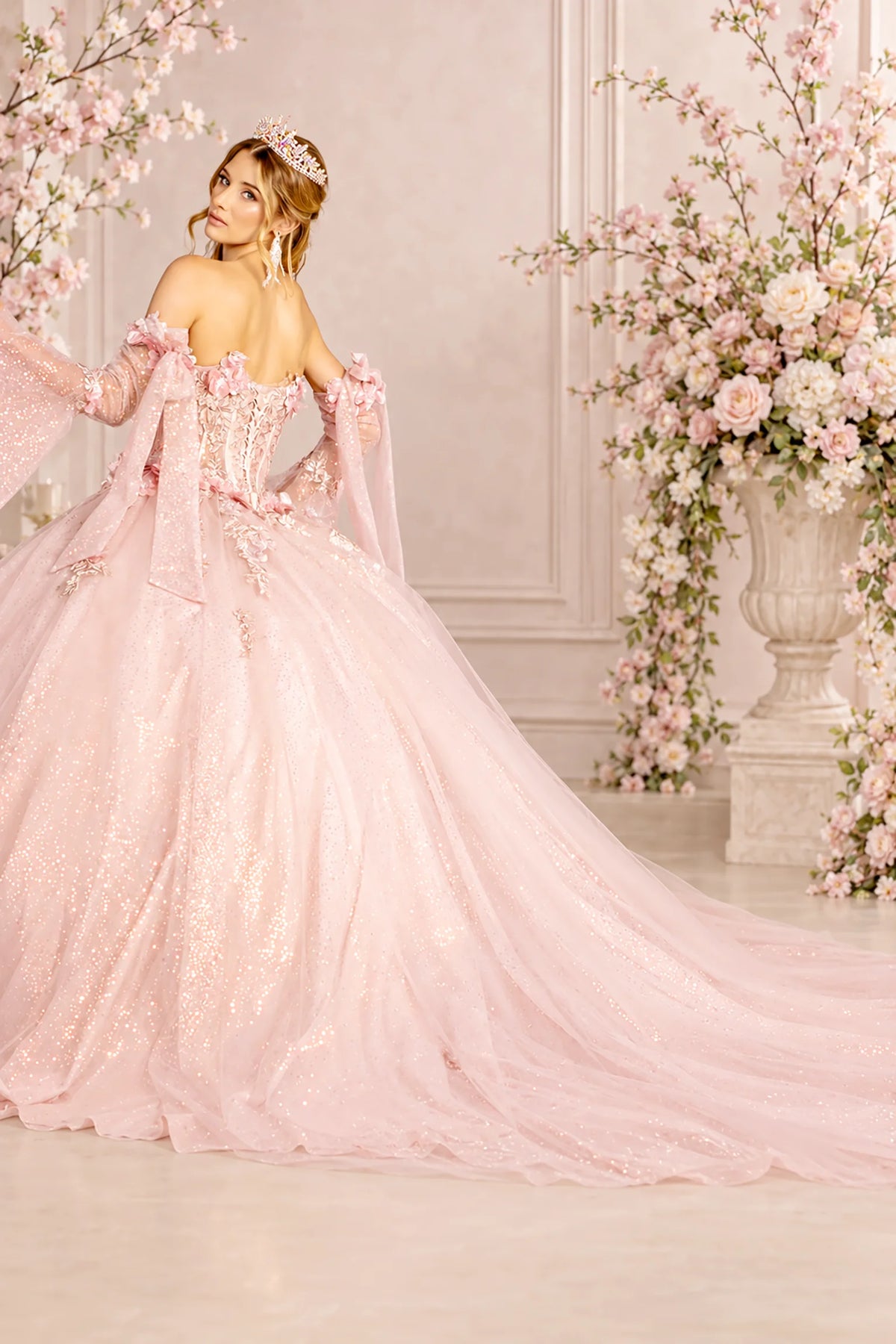 Sweeping back view of the Blush quinceañera ball gown with lace-up corset and train