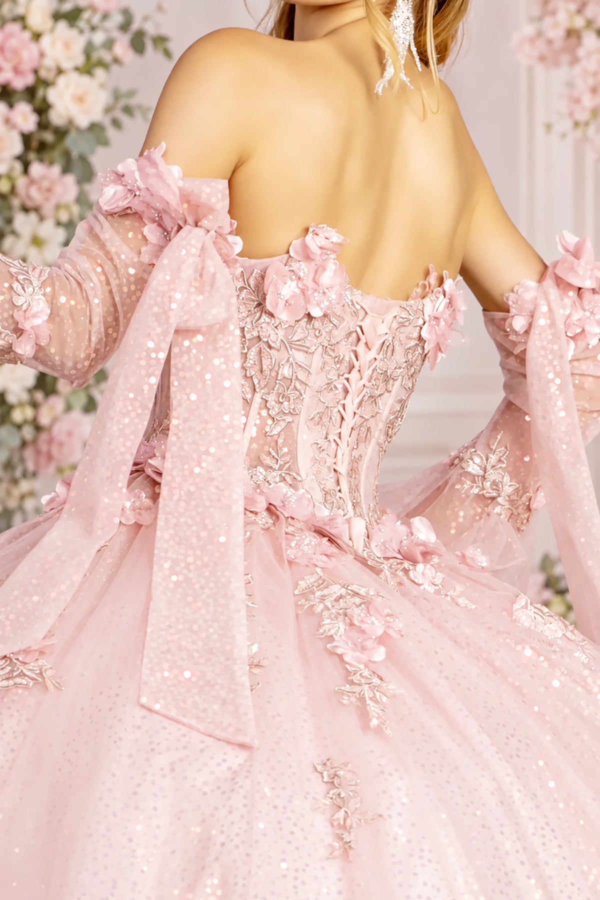 Lace-up corset detail finishes the Blush quinceañera ball gown with floral sleeves