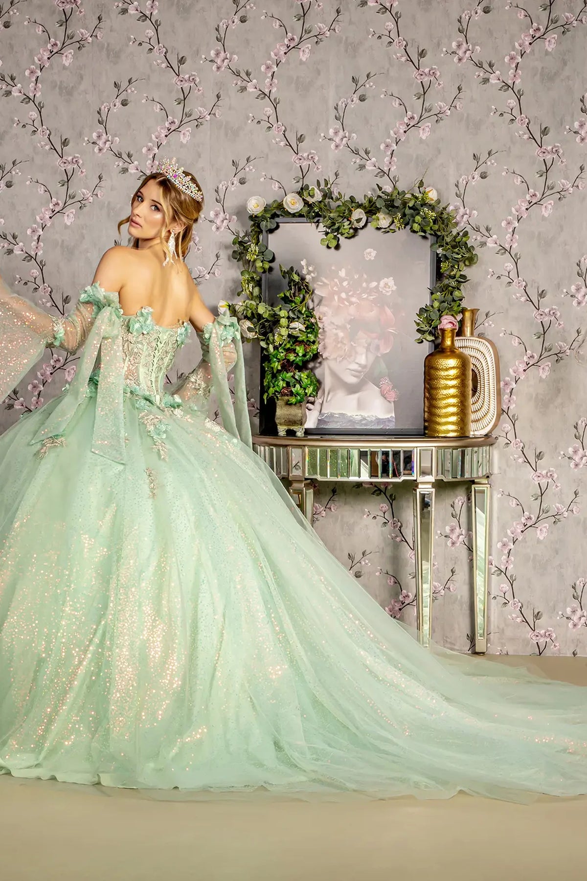 Layered skirt showcases the Sage quinceañera ball gown with 3d floral embroidery.