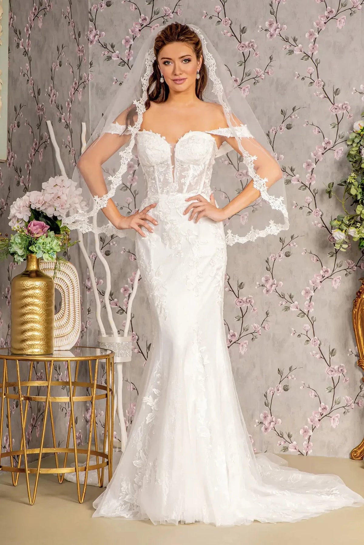A glittering mermaid skirt extends below the fitted floral bodice of this white wedding gown.