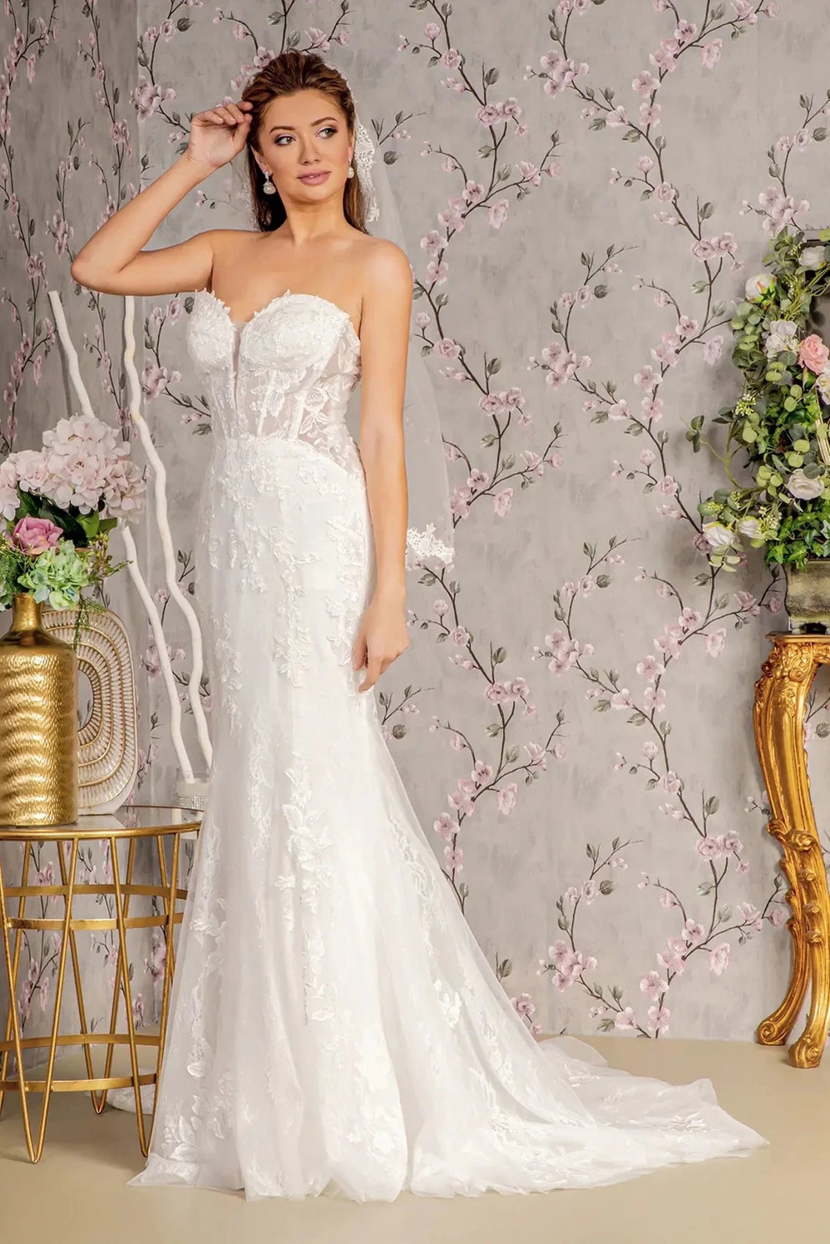 Floral embroidery shapes the sculpted sweetheart bodice of this white mermaid wedding gown.