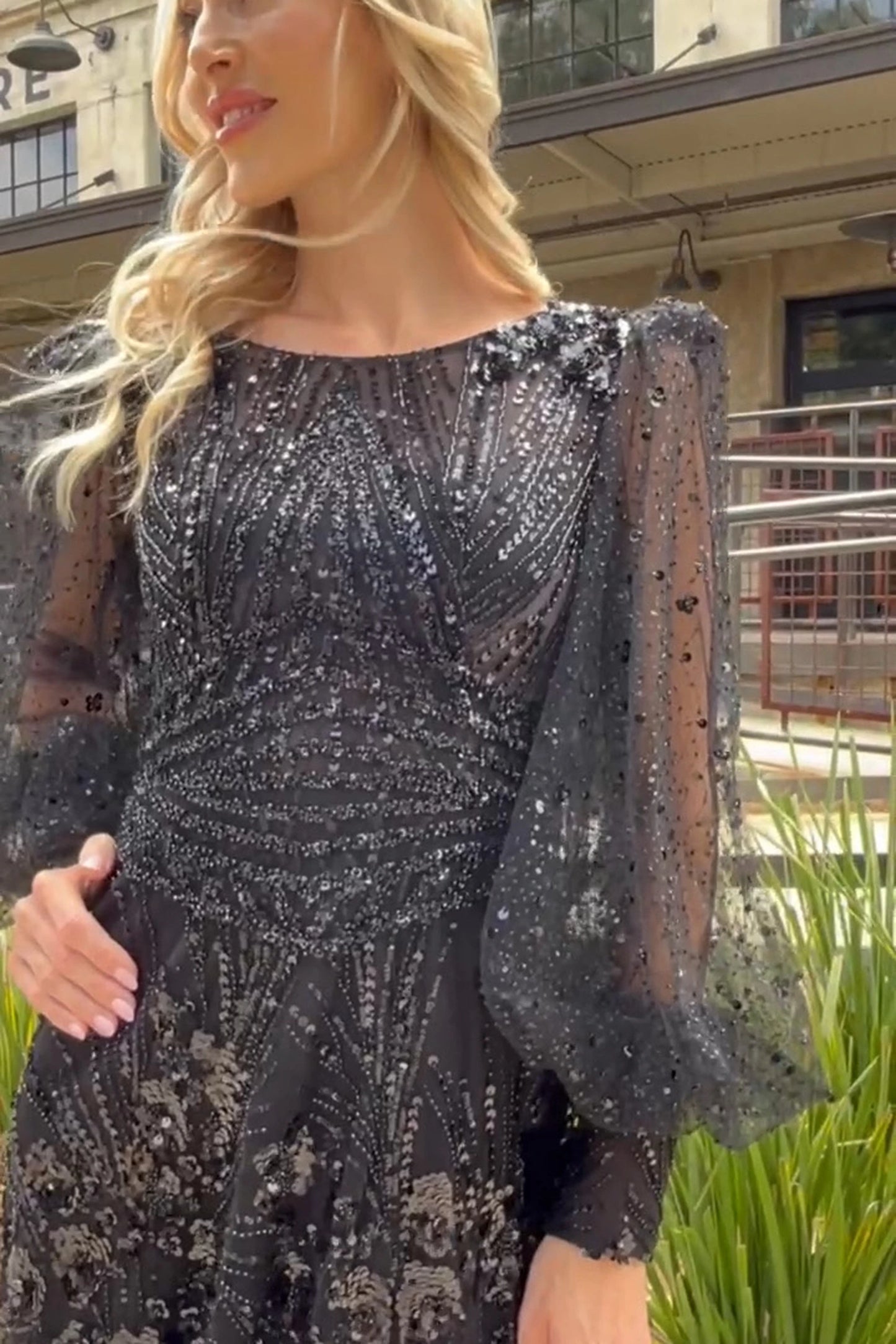 Black mother of the bride dress featuring embellished bodice flowing into a mesh a-line skirt