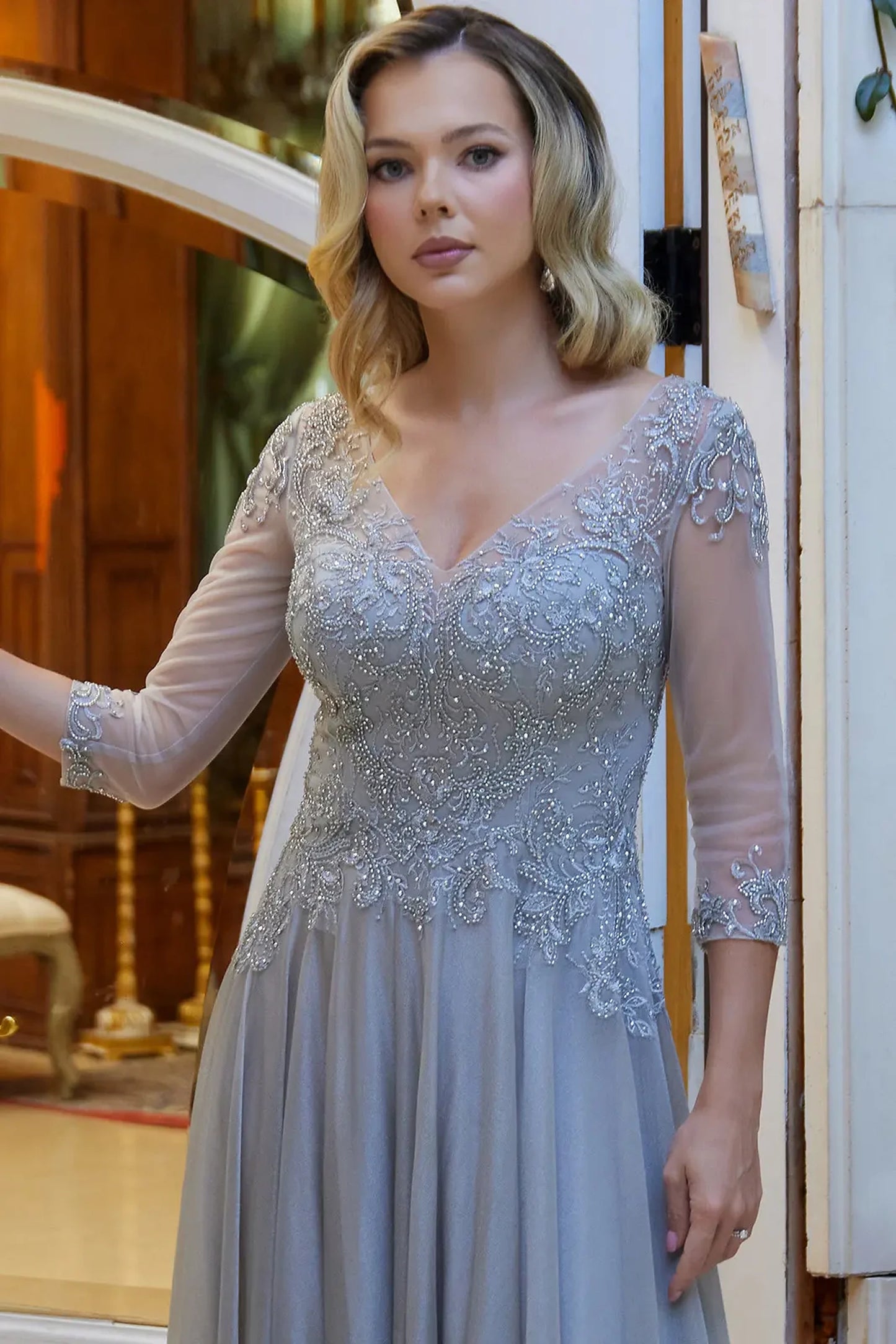 Silver mother of the bride dress featuring illusion v-neck bodice with 3/4 sleeve and beads, embroidery, jewel