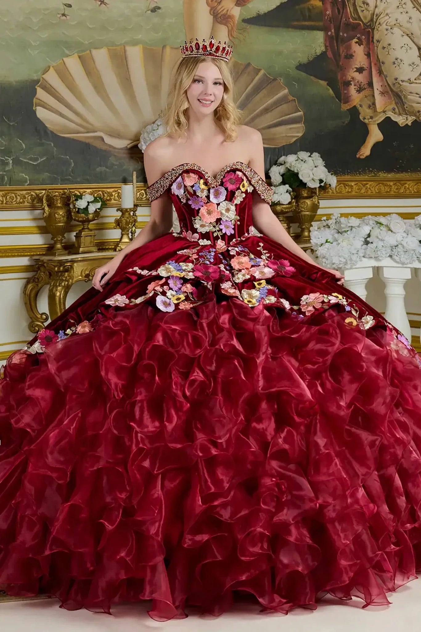 burgundy off the shoulder ball gown with floral and rhinestone embellishments in an elegant indoor setting