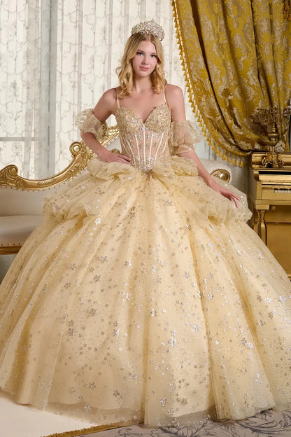 Woman in a gold quince ball gown with intricate details in a opulent room.