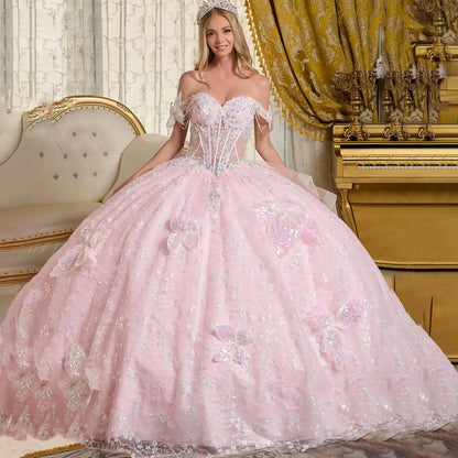 Woman in a pink quinceañera dress with floral details in an elegant room front view.