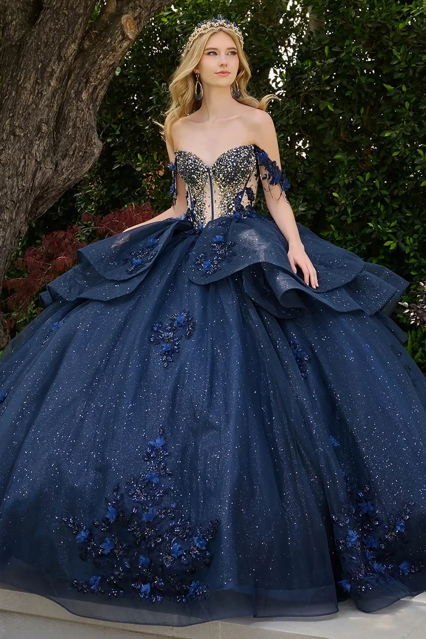Navy quinceañera ball gown featuring jeweled embroidery, detachable off-shoulder straps beaded fringe and glitter overskirts