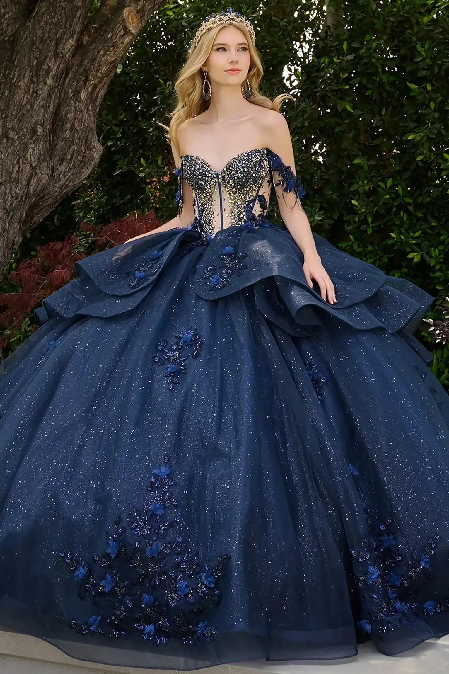 Navy quinceañera ball gown with glitter mesh skirt, layered ruffled overskirt and accentuated waistline