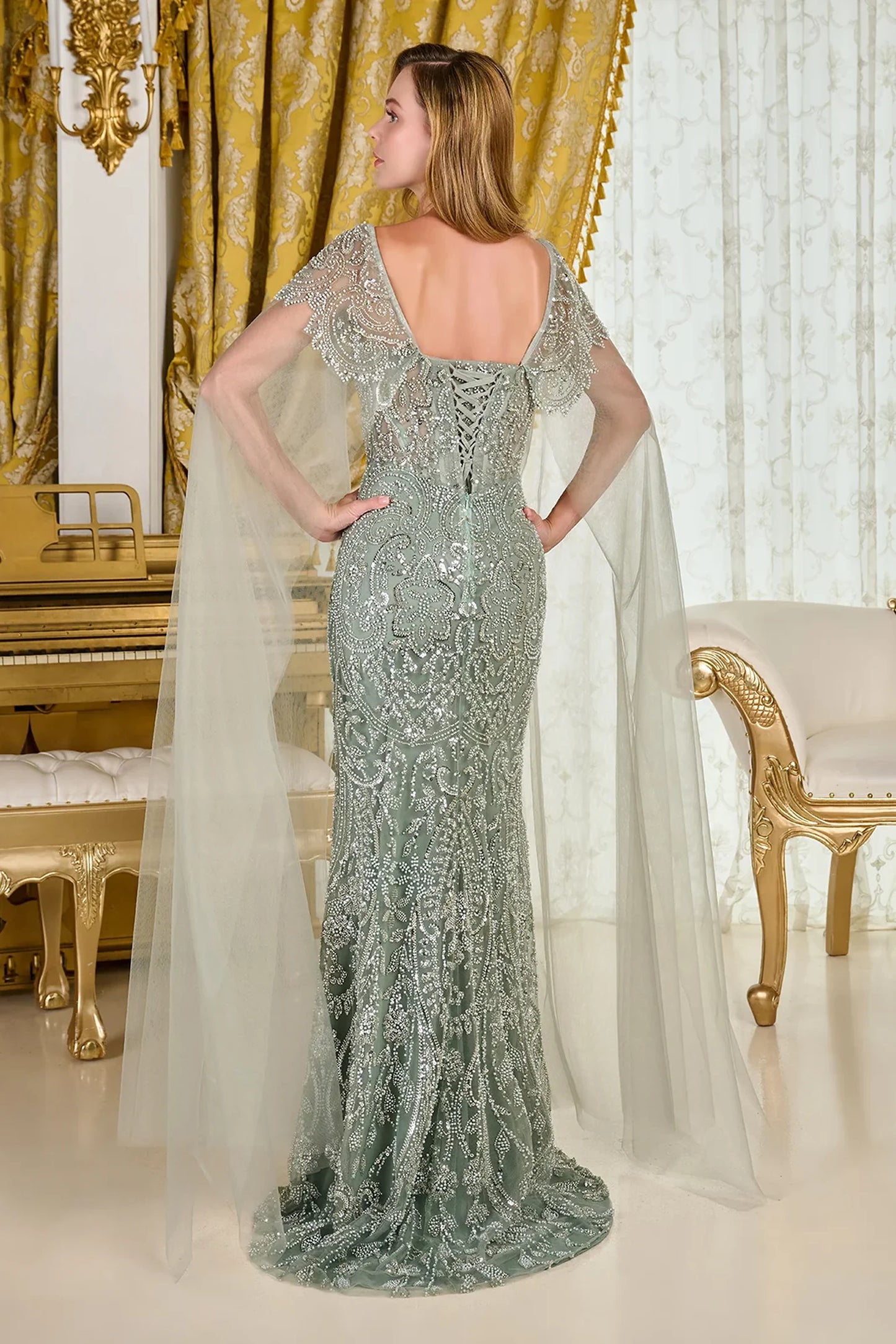 Sage fitted mother of the bride dress with corset back and cape sleeve