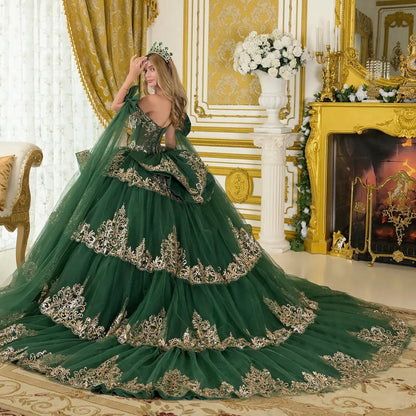Woman in a green and gold evening gown in an opulent room.