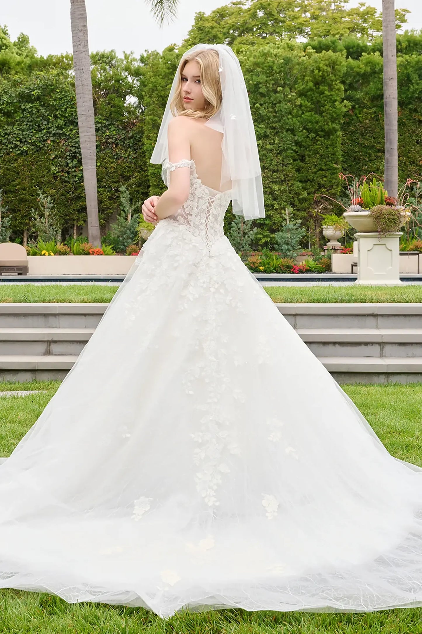 Off-white quinceañera ball gown featuring beadwork and floral embroidery on mesh skirt