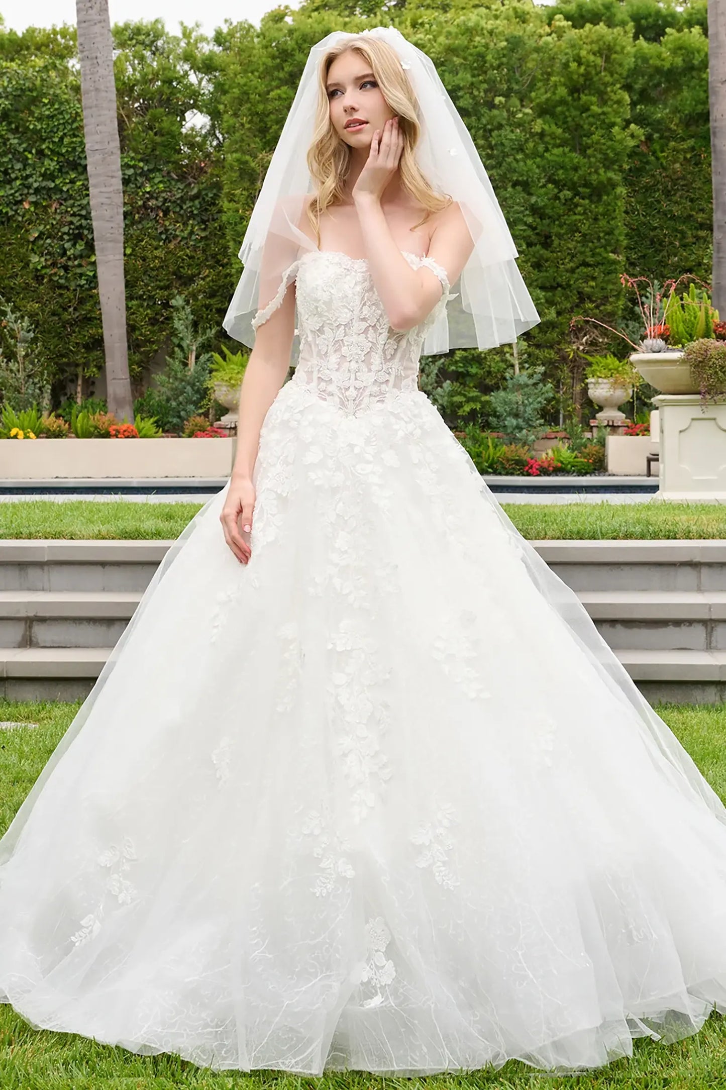 Off-white quinceañera ball gown with corset bodice and Basque waistline