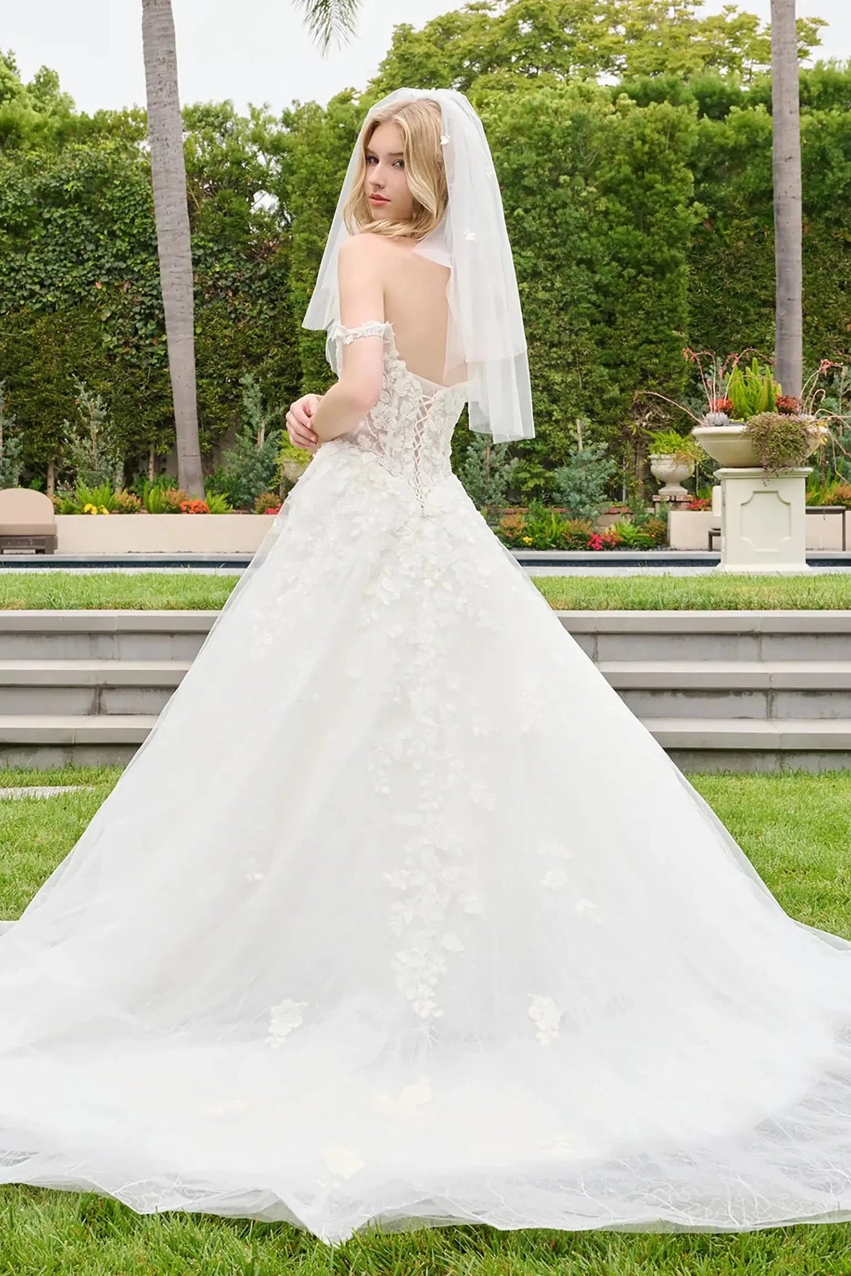 Off-white quinceañera ball gown featuring beadwork and floral embroidery on mesh skirt