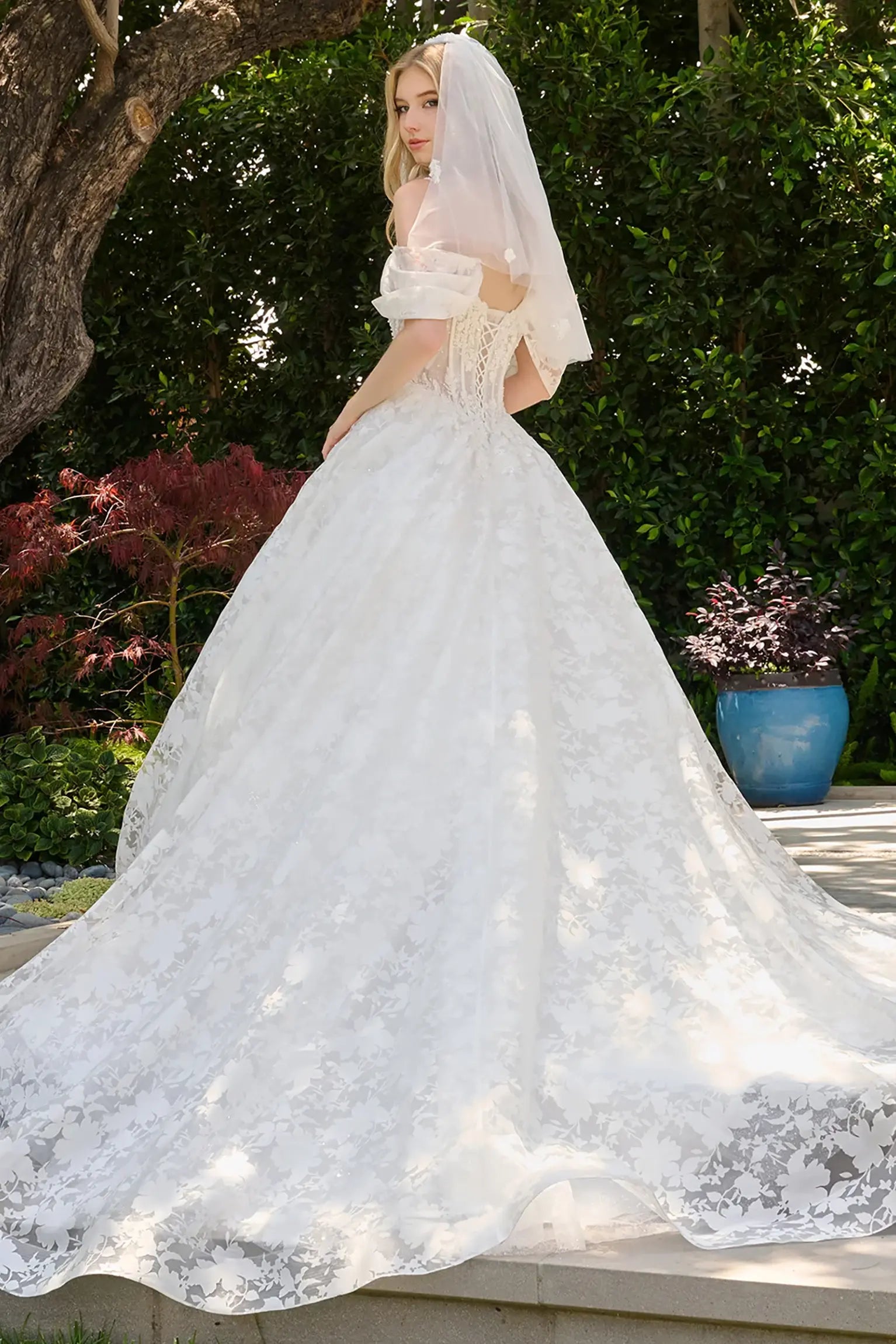 Off-white wedding dress with mesh corset bodice embellished with beads, sequins and floral embroidery