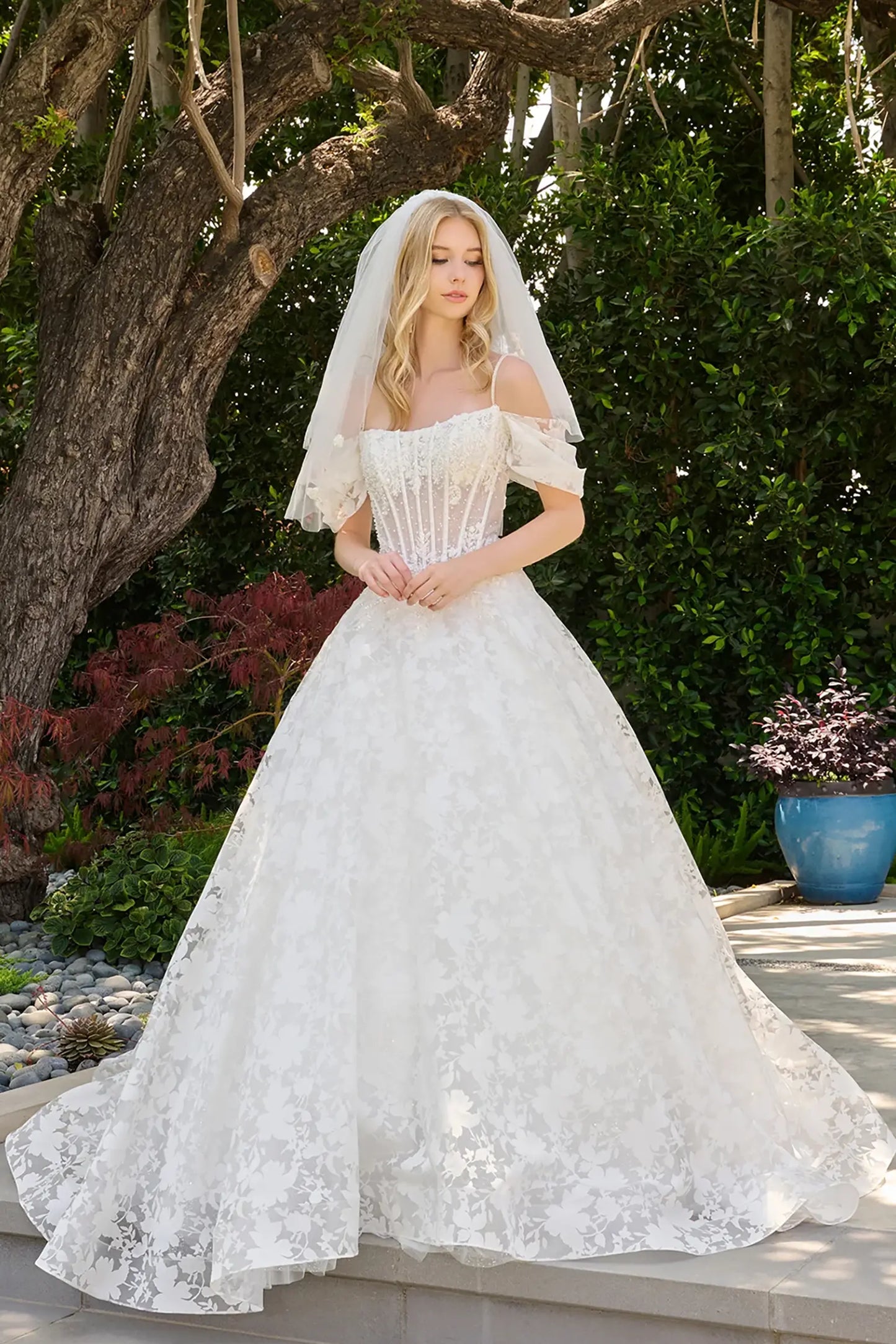 Off-white wedding dress showcasing Basque waistline where embroidery extends seamlessly into the skirt