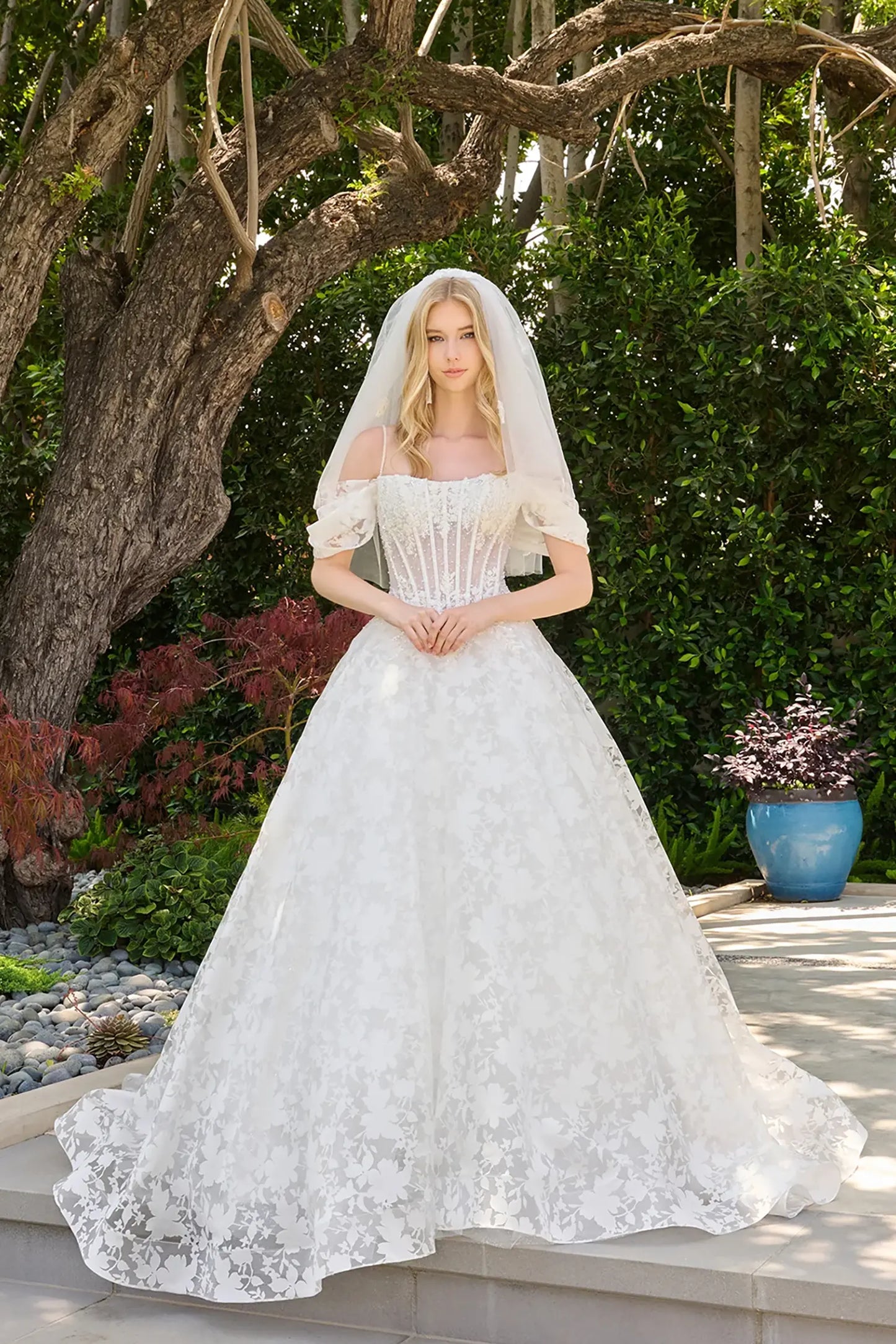 Off-white wedding dress crafted with organza jacquard sleeves and skirt patterned with floral motifs