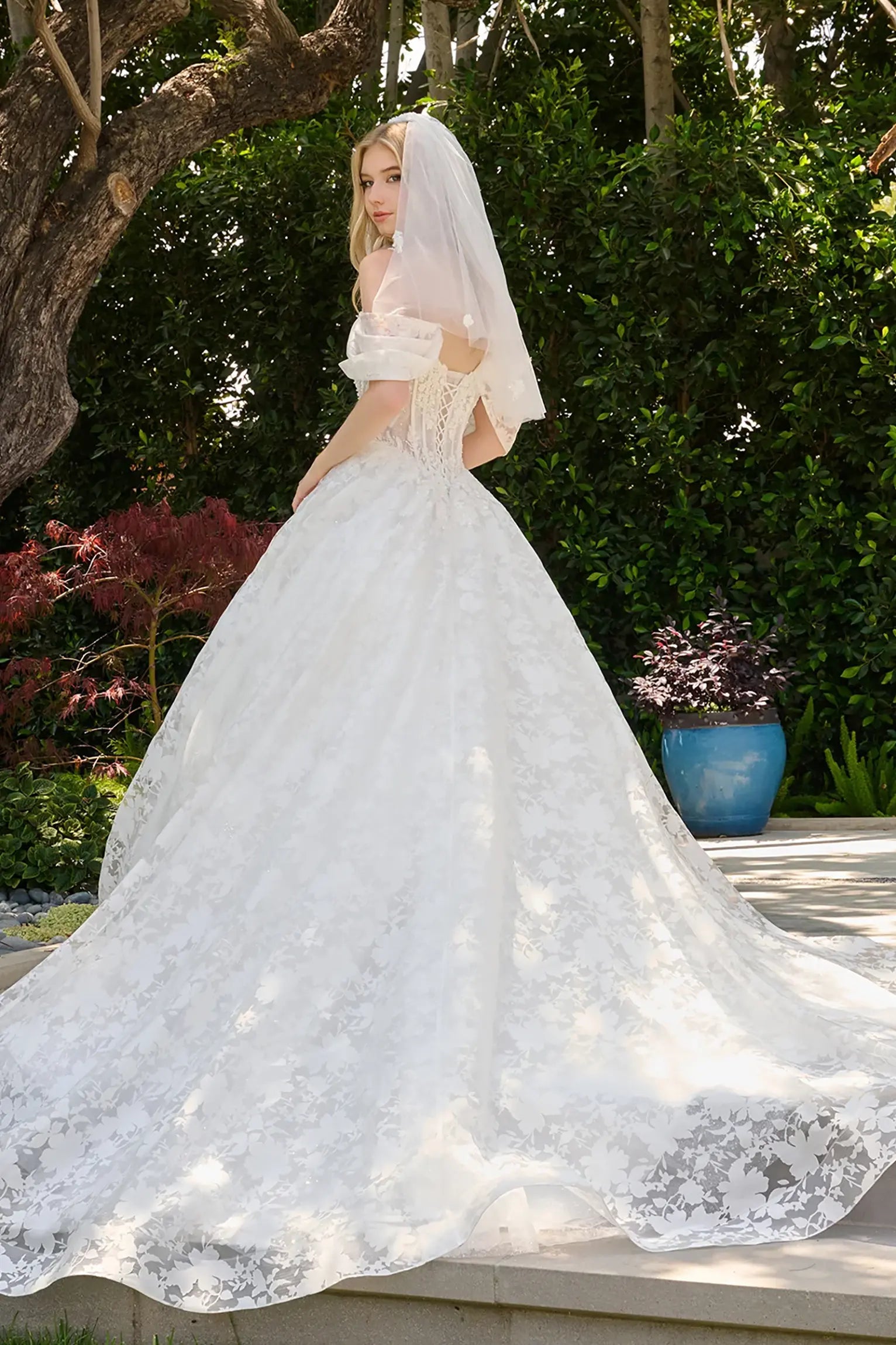 Off-white wedding dress layered over glitter mesh underlayer that adds subtle sparkle and depth lace back up